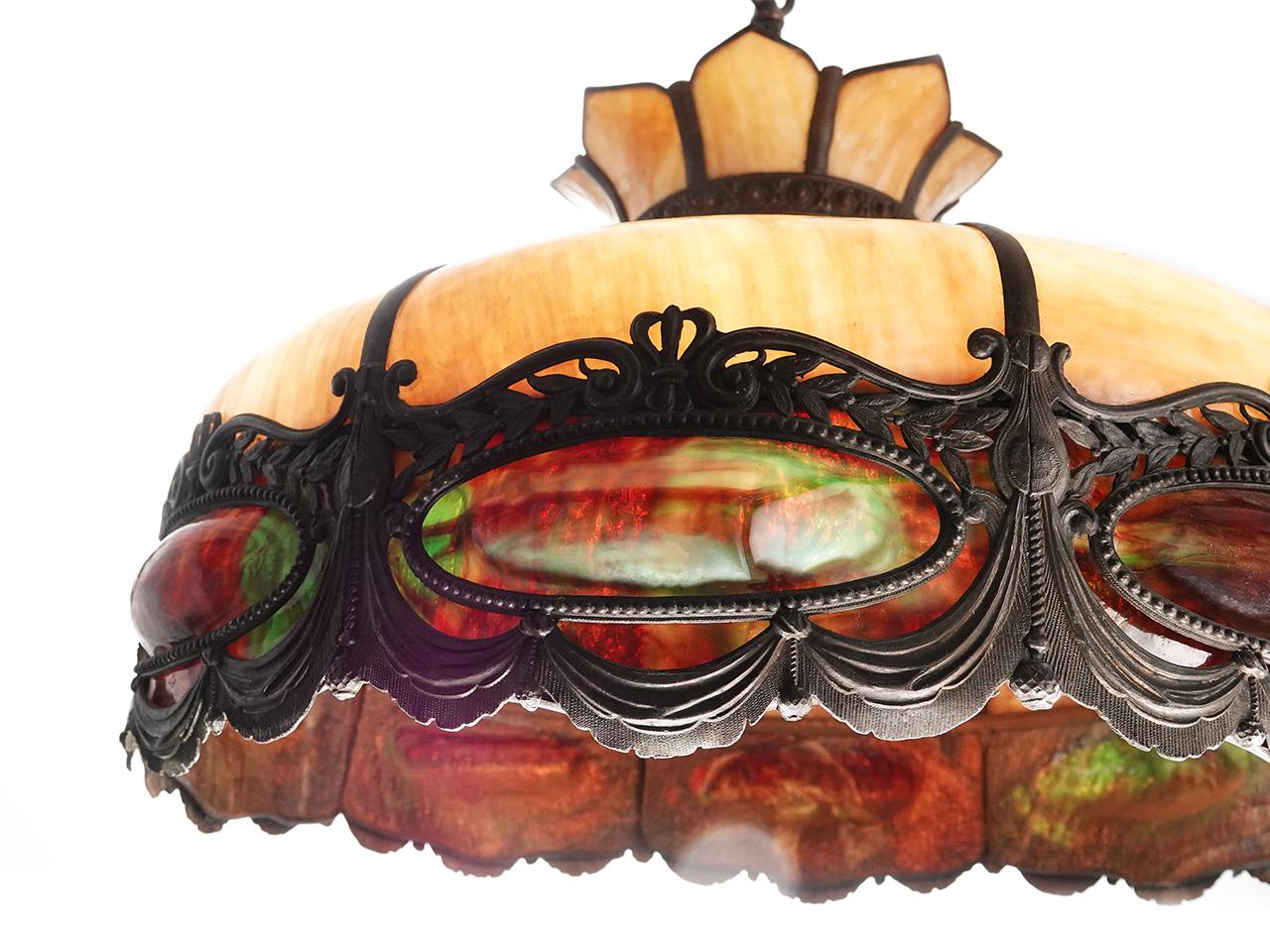 This is a large, impressive original stained slump glass chandelier. The top is a cream/white and the bubble curved medallions are multicolored wit a deep red and green.
This can be finished with chain to a drop length you require.