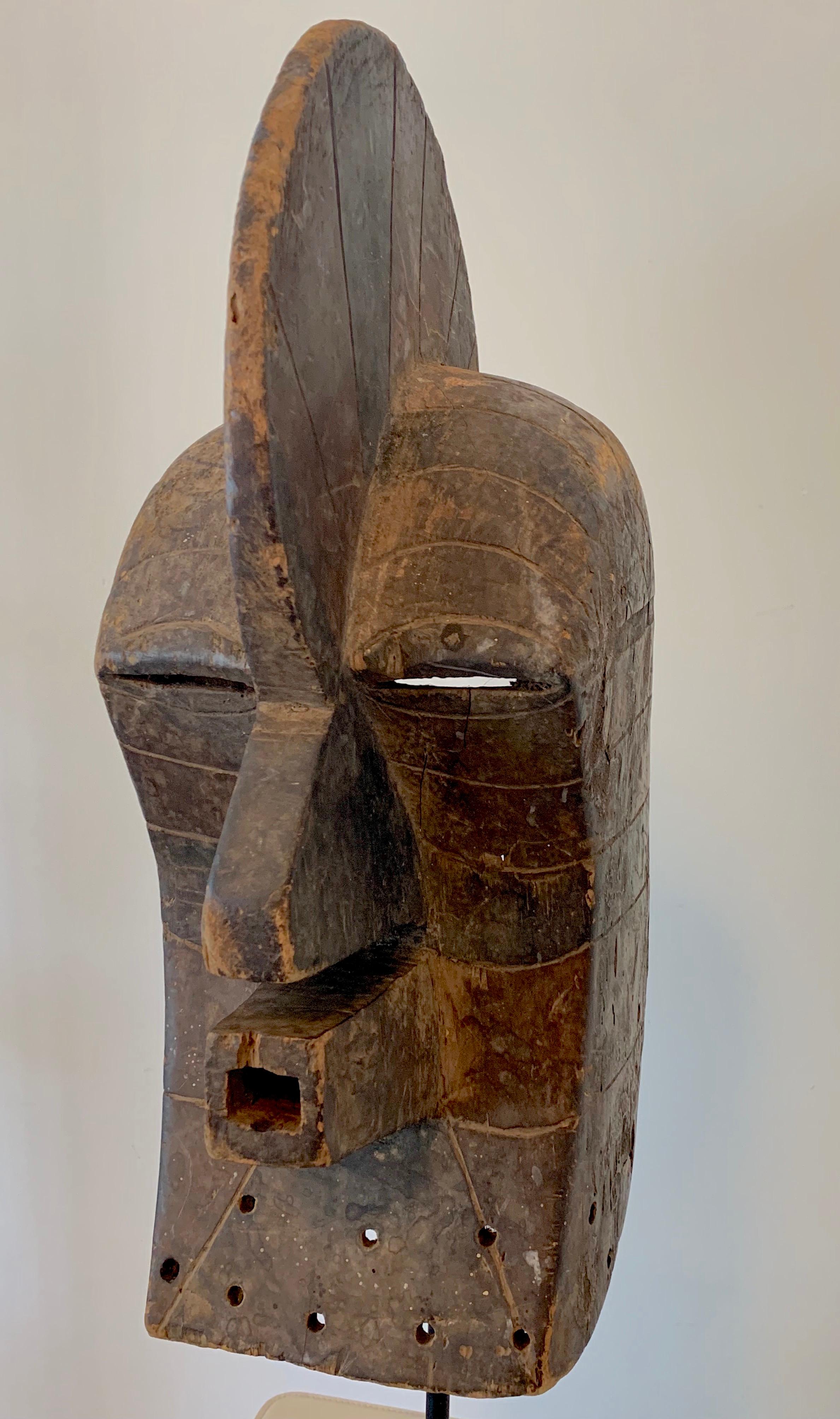 One of a kind early 19th century African hand carved Dogon wooden mask from Mali was worn during the dances performed by tribe. Custom museum iron support stand is included.

Actual mask measurements:
21 inches high
8 inches wide
11.5 inches deep.