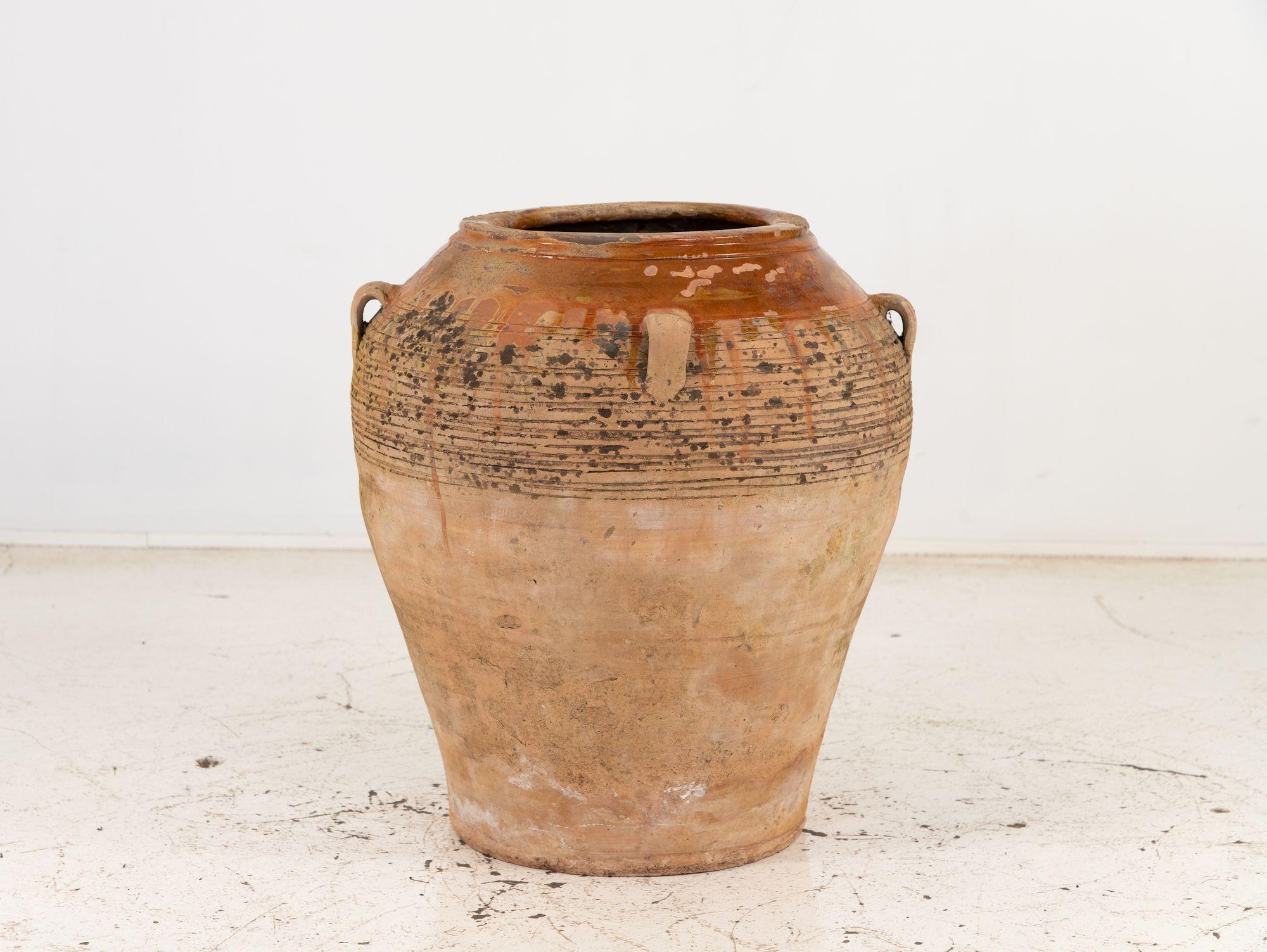 This four-handled earthenware pot is a captivating piece that exudes both rustic charm and functionality. Crafted with skill and attention to detail, it showcases the timeless beauty of earthenware ceramics. The pot features four gracefully curved