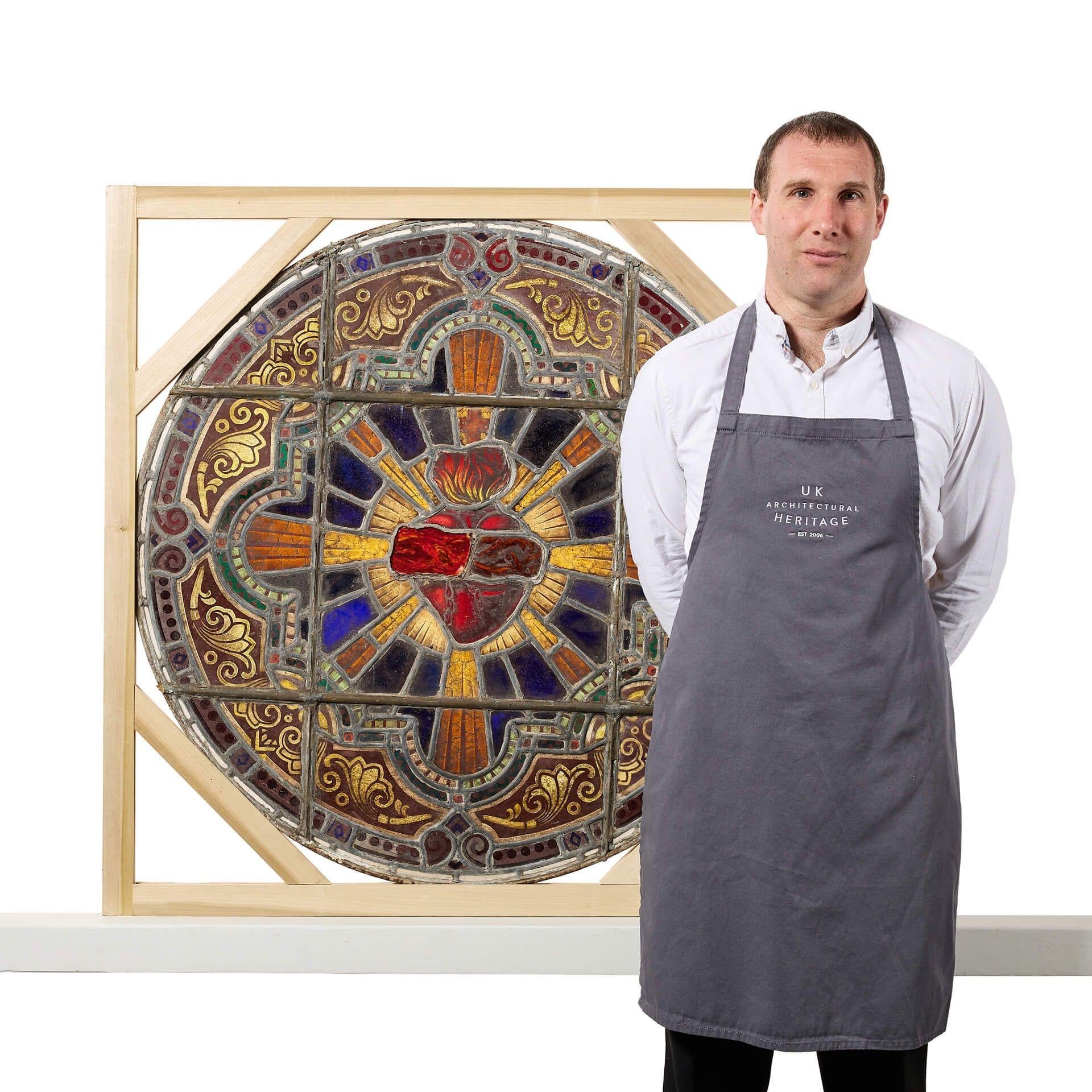 A large ø101cm antique ecclesiastical roundel stained glass panel, dating to circa 1890. If looking for multiple, we are also selling other roundels in a very similar design.

This antique stained glass window features a vibrant array of coloured