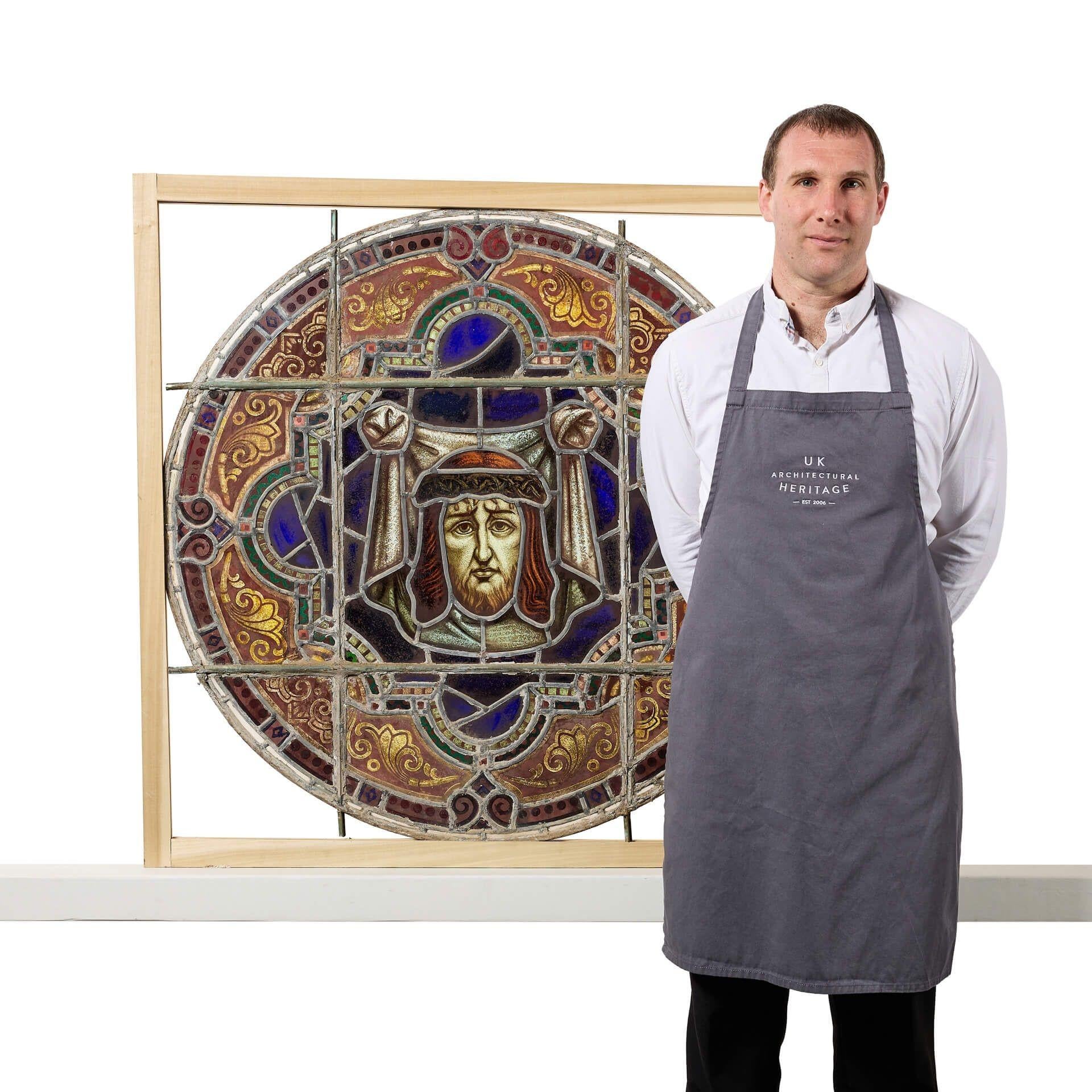  A large ø101cm antique ecclesiastical roundel stained glass panel, dating to circa 1890. If looking for multiple, we are also selling other roundels in a very similar design. 
 
This antique stained glass window features a vibrant array of coloured