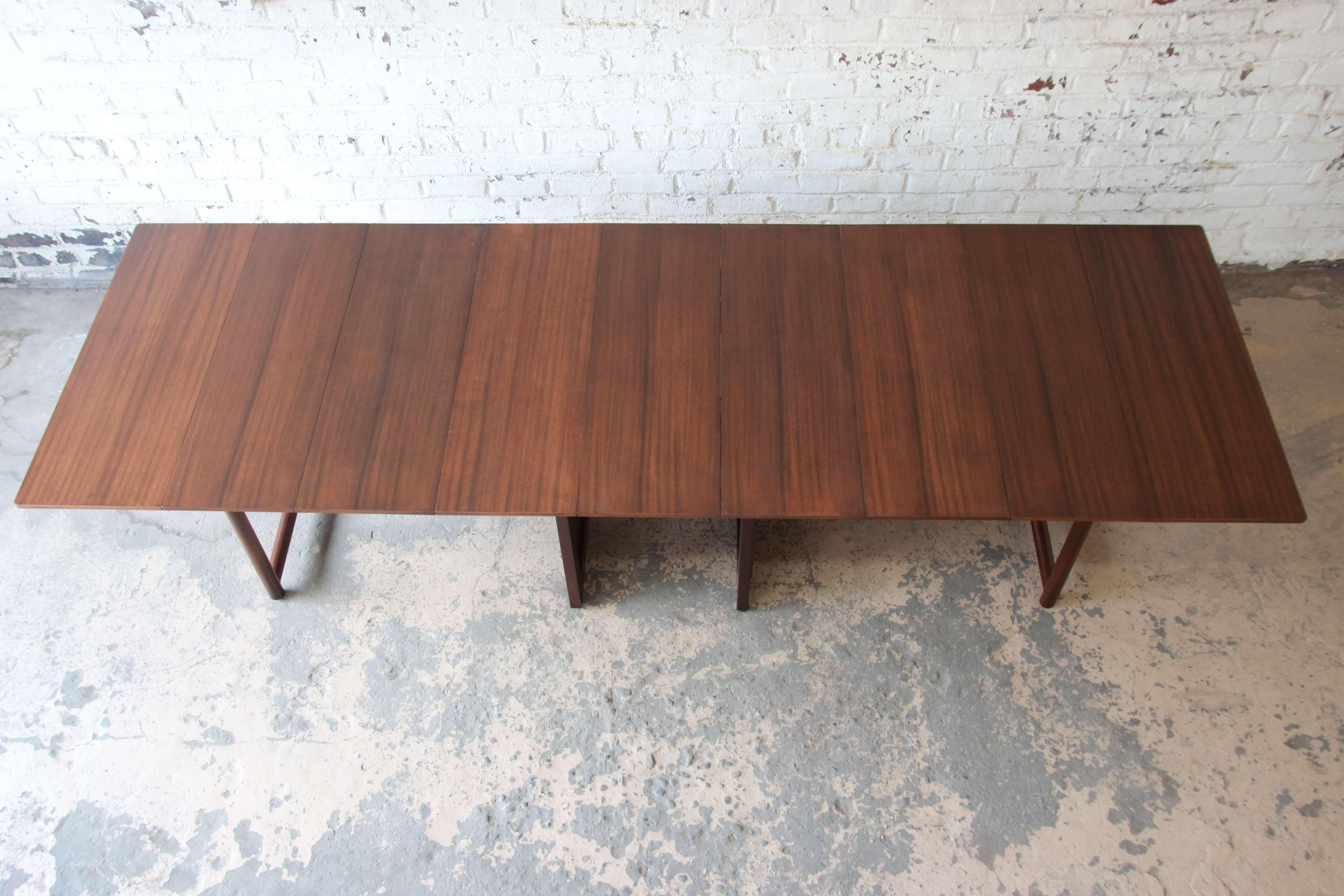 Offering a substantial and amazingly versatile Edward Wormley extension dining table for Dunbar. The table measures at its smallest point 28.5
