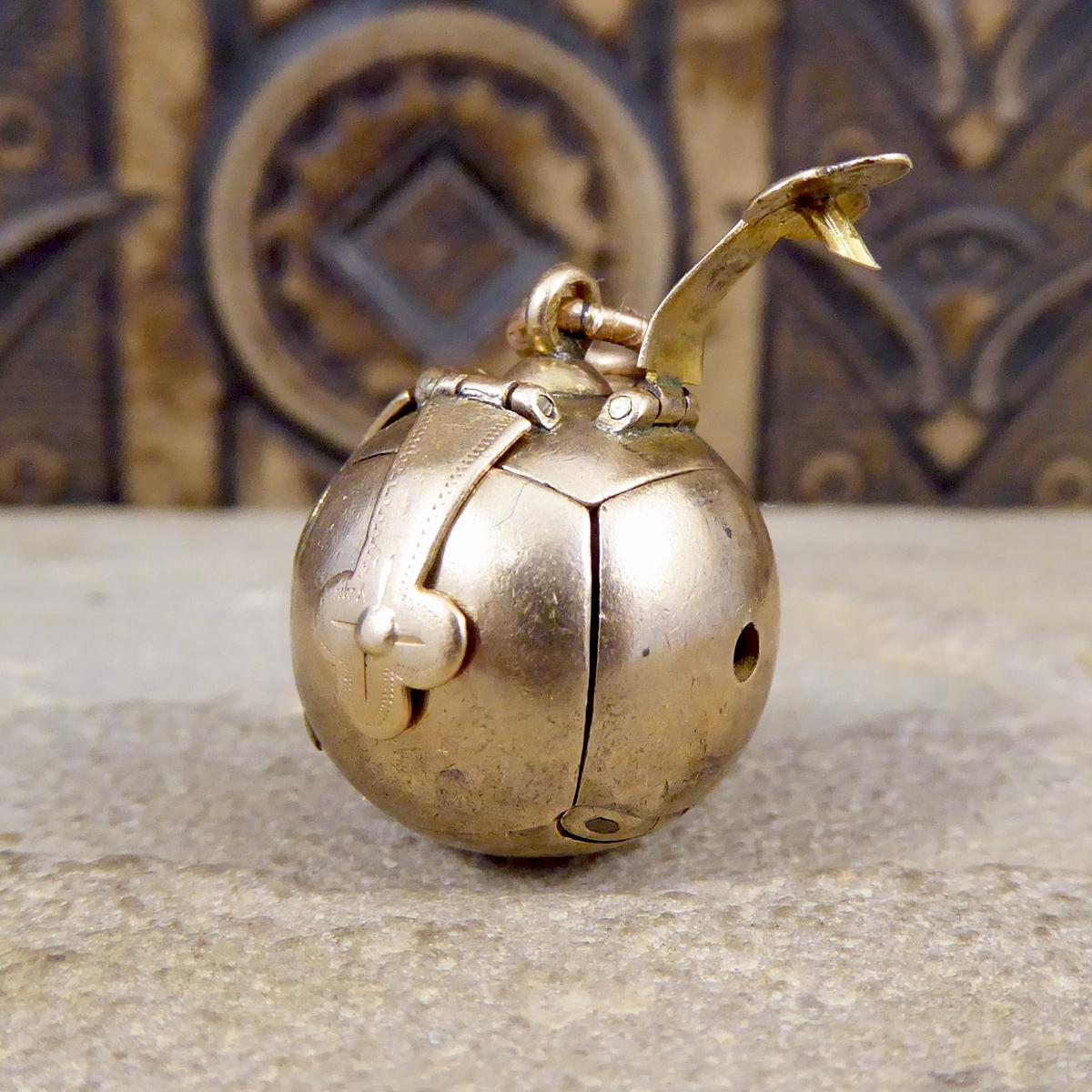 This Unique Antique Folding Ball pendant appears initially to simply be a Silver gilt and Gold sphere, however when unhinged opens out to show a cross shape formed by six pyramids. On these, are a variety of symbols including the tools of