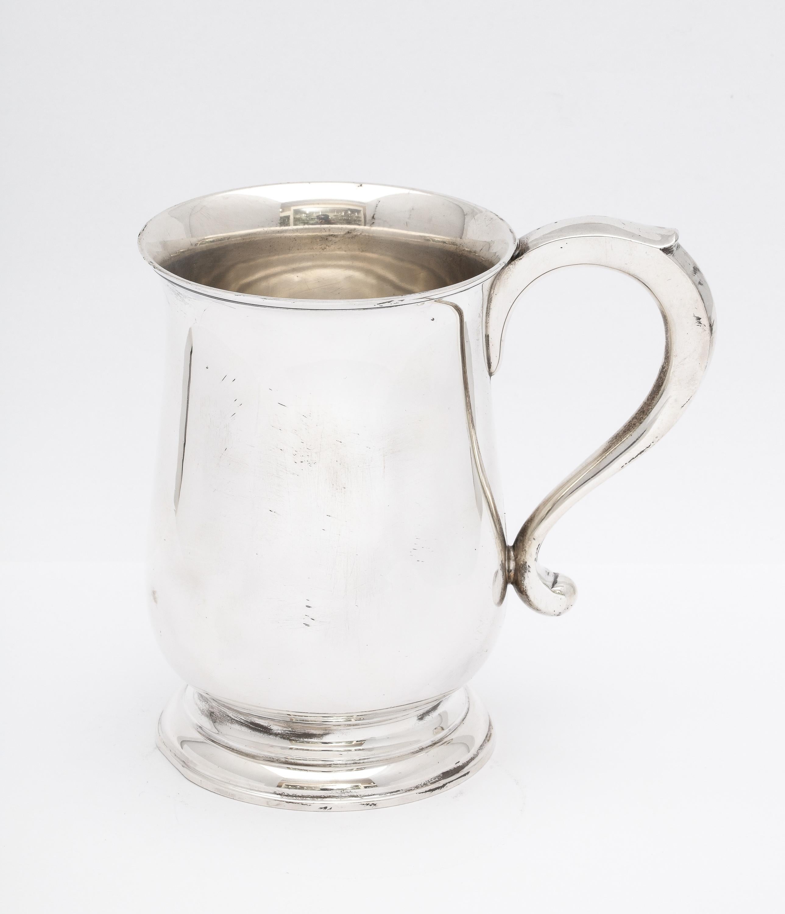 Large, sterling silver, Edwardian period, George III-style tankard, London, year-hallmarked for 1908, Blackmore and Fletcher, Ltd. - makers. Measures 5 inches high x 3 3/4 inches diameter across widest area of body x 5 1/4 inches wide from outer