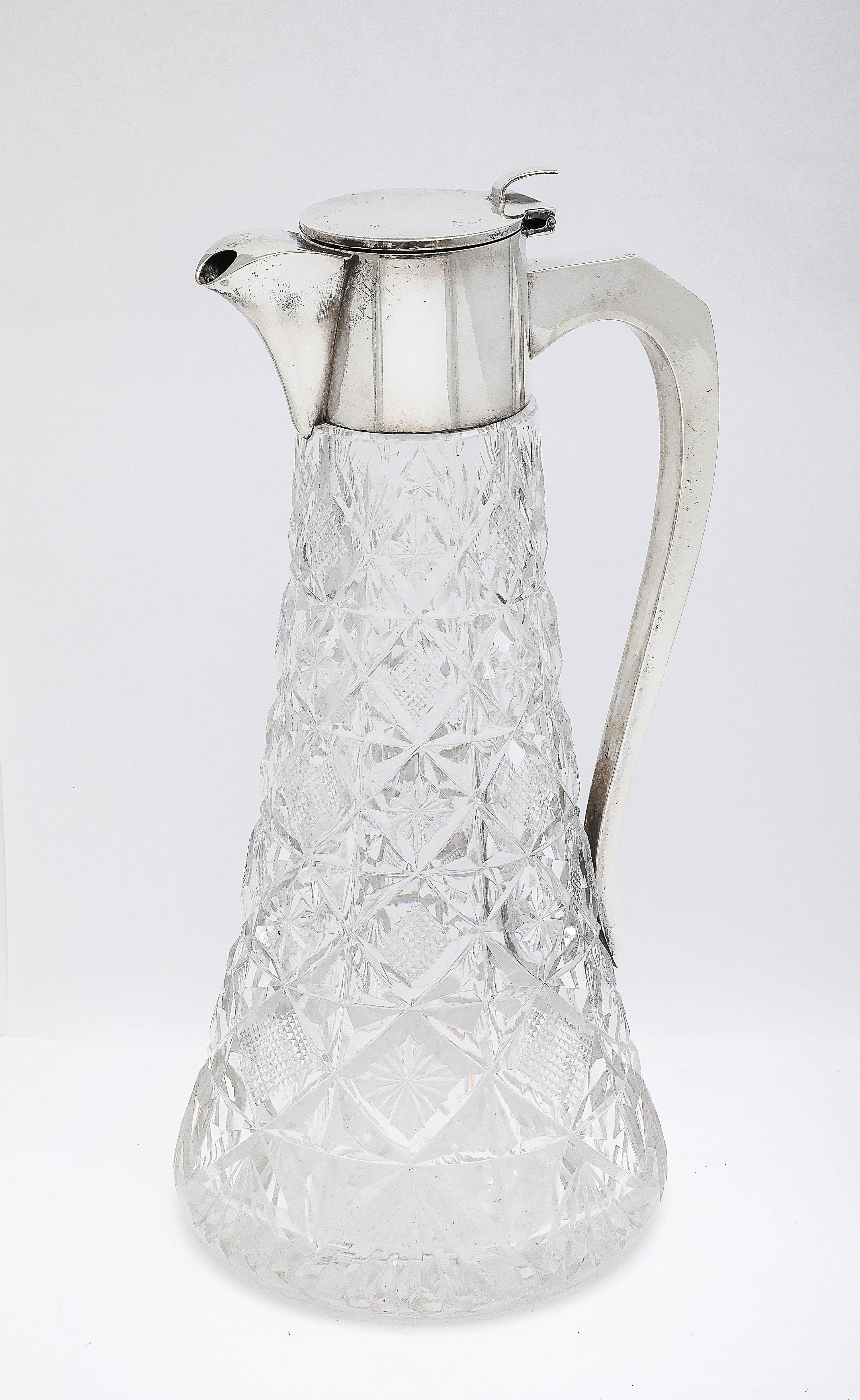 Large, Edwardian Period, sterling silver-mounted cut crystal claret jug, Sheffield, England, Walker and Hall - makers. Measures 11 inches high (at highest point) x 5 inches diameter (at widest point) x  5 inches across from outer edge of spout to
