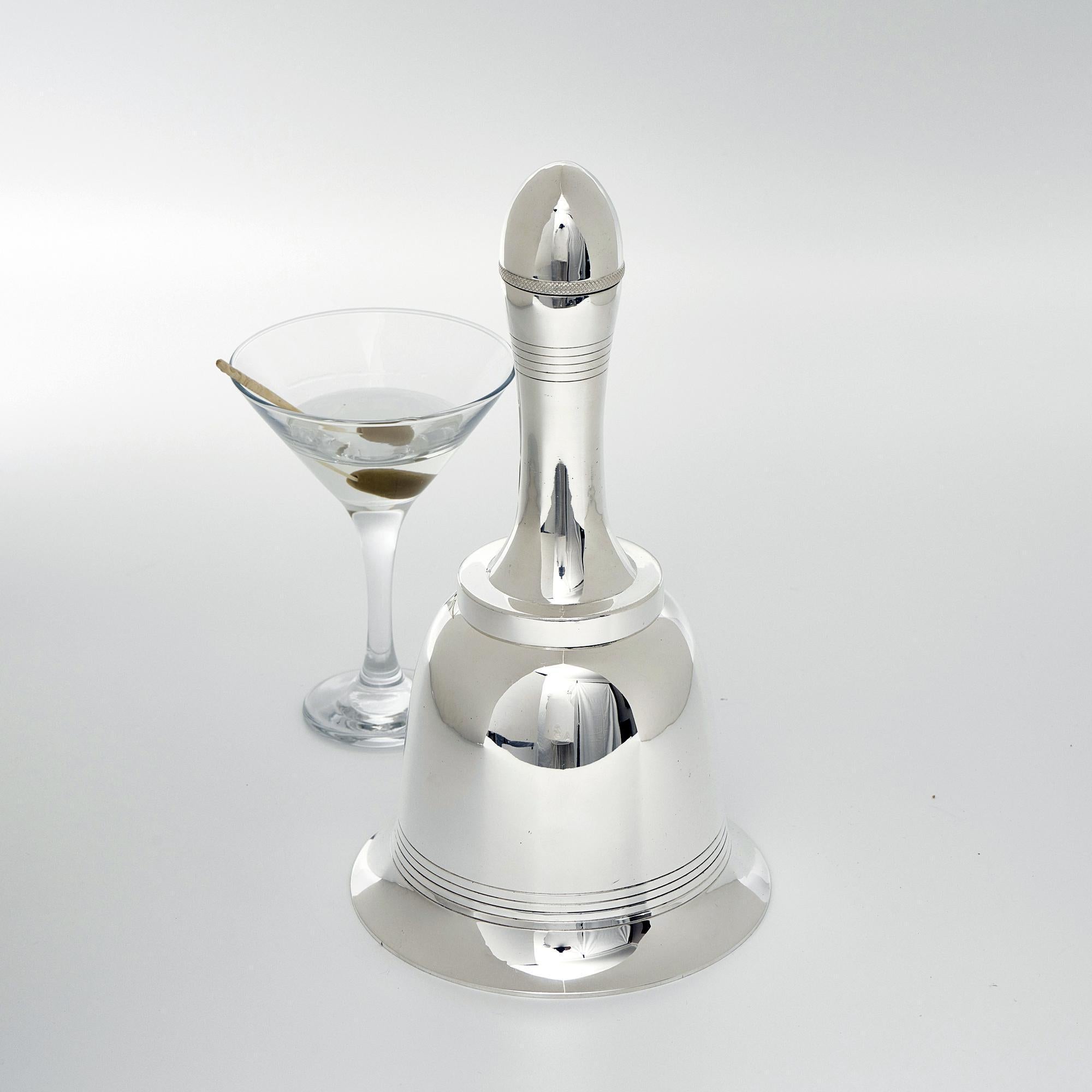 Classic 1930s silver-plated novelty cocktail shaker in the form of a hand bell, made by Asprey & Company. The upper section of the of the handle unscrews to allow pouring while the lower part of the handle unscrews for ingredients to be added. The