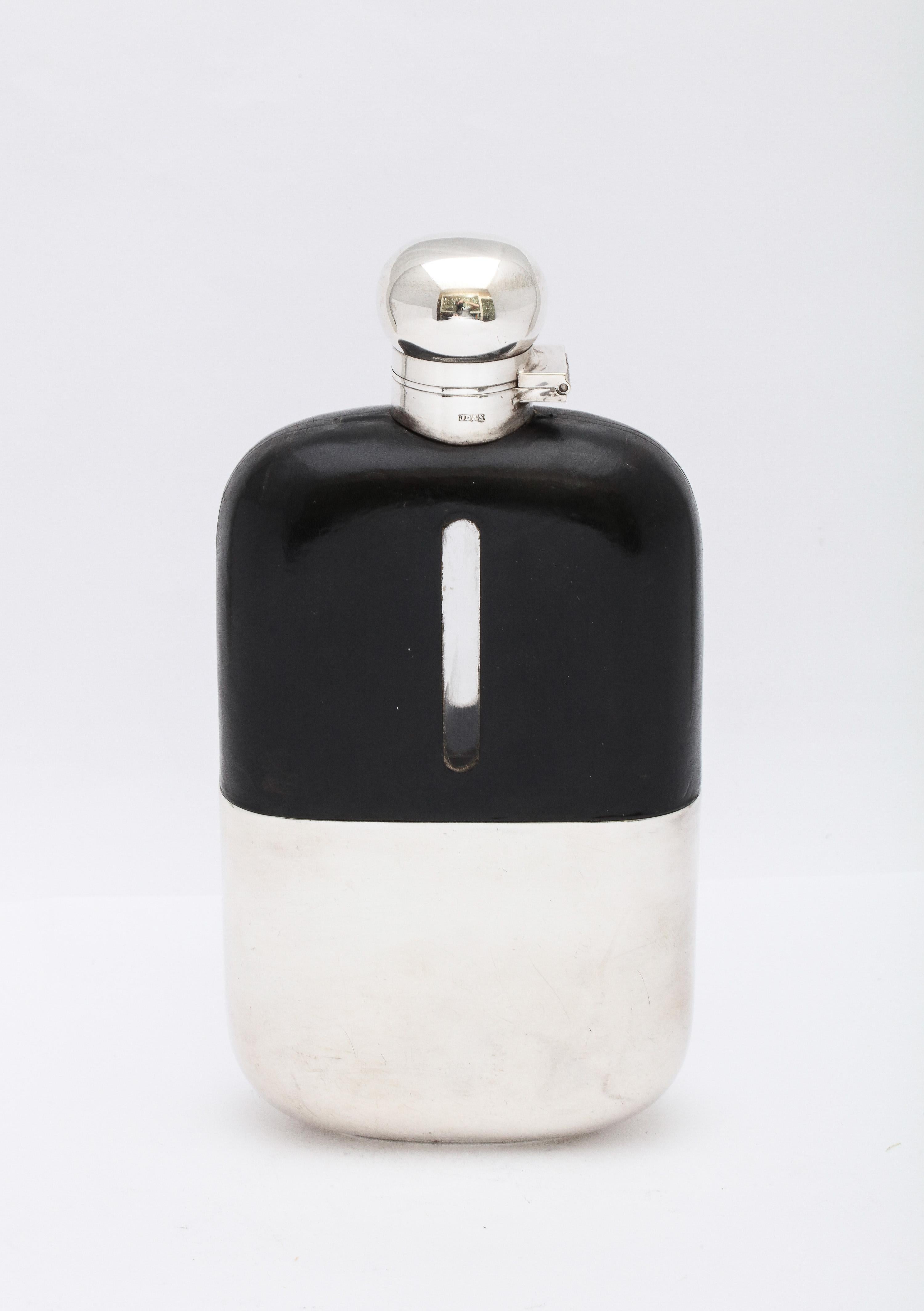 Large, Edwardian, silver-plated and leather-mounted glass flask with hinged lid (having a cork insert),  Sheffield, England, Ca. 1900, James Dixon and Sons, - makers. Leather has been cut on both sides of the flask in an oblong see-through so that