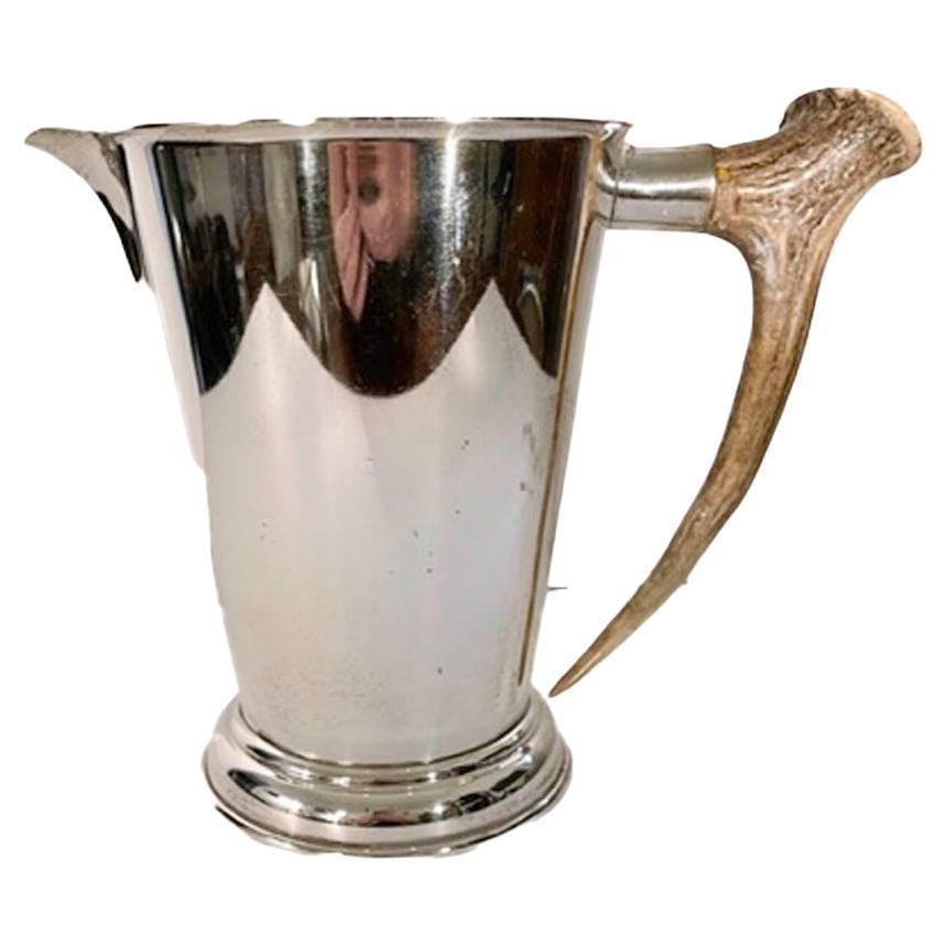 Large silver plate water pitcher by P.H. Vogel & Co. of tapered form on a stepped foot and with a natural antler handle.