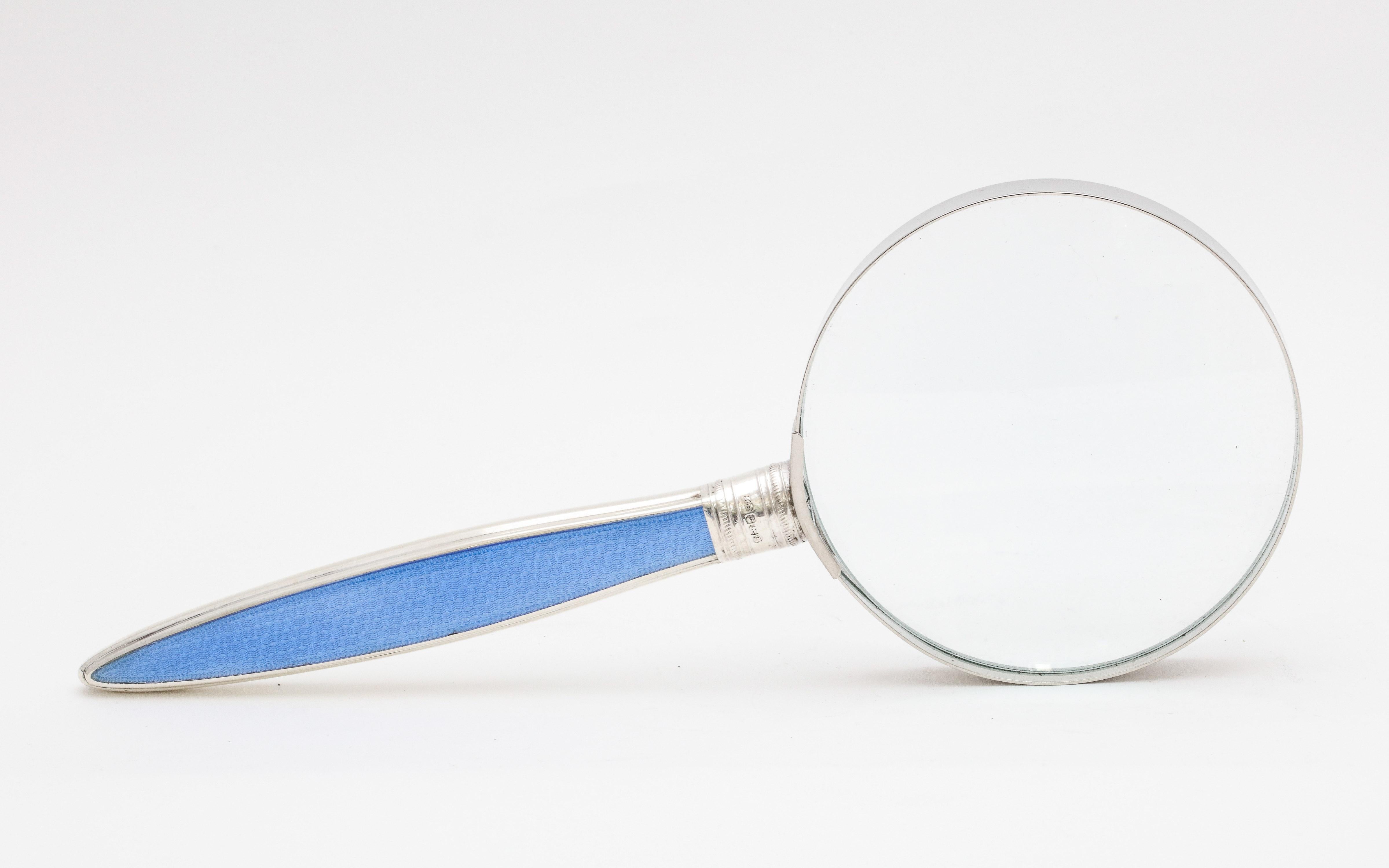 Large, Edwardian, sterling silver and blue guilloche enamel - mounted magnifying glass, Sheffield, England, year hallmarked for 1909, John Biggin - maker. Measures: 9 1/2 inches long x 3 3/4 inches in diameter across glass. Glass itself has a metal