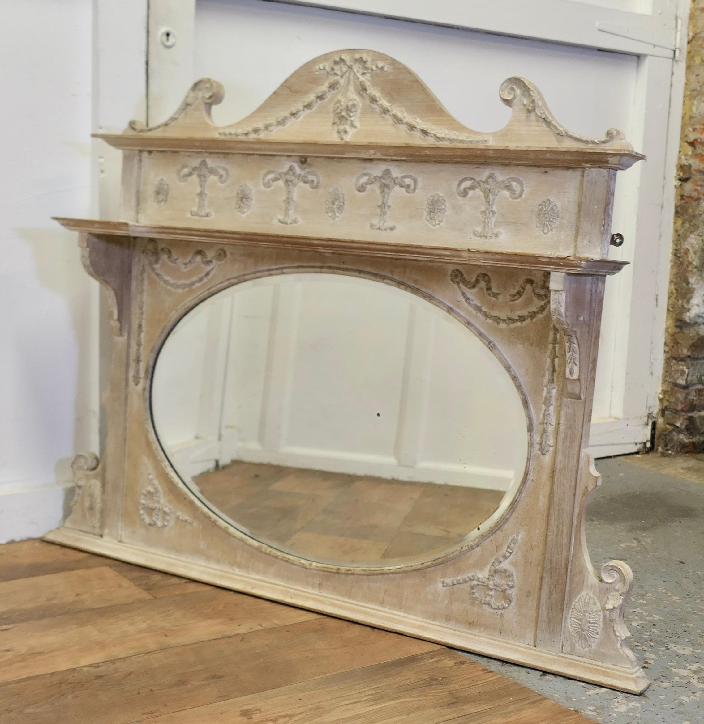 Large Edwardian Stripped Pine Overmantel 

This is an attractive piece, it is made in pine, the piece has a swan neck pediment to the top, a large oval mirror which has a small shelf over and the mirror retains the original gesso decoration, 
The