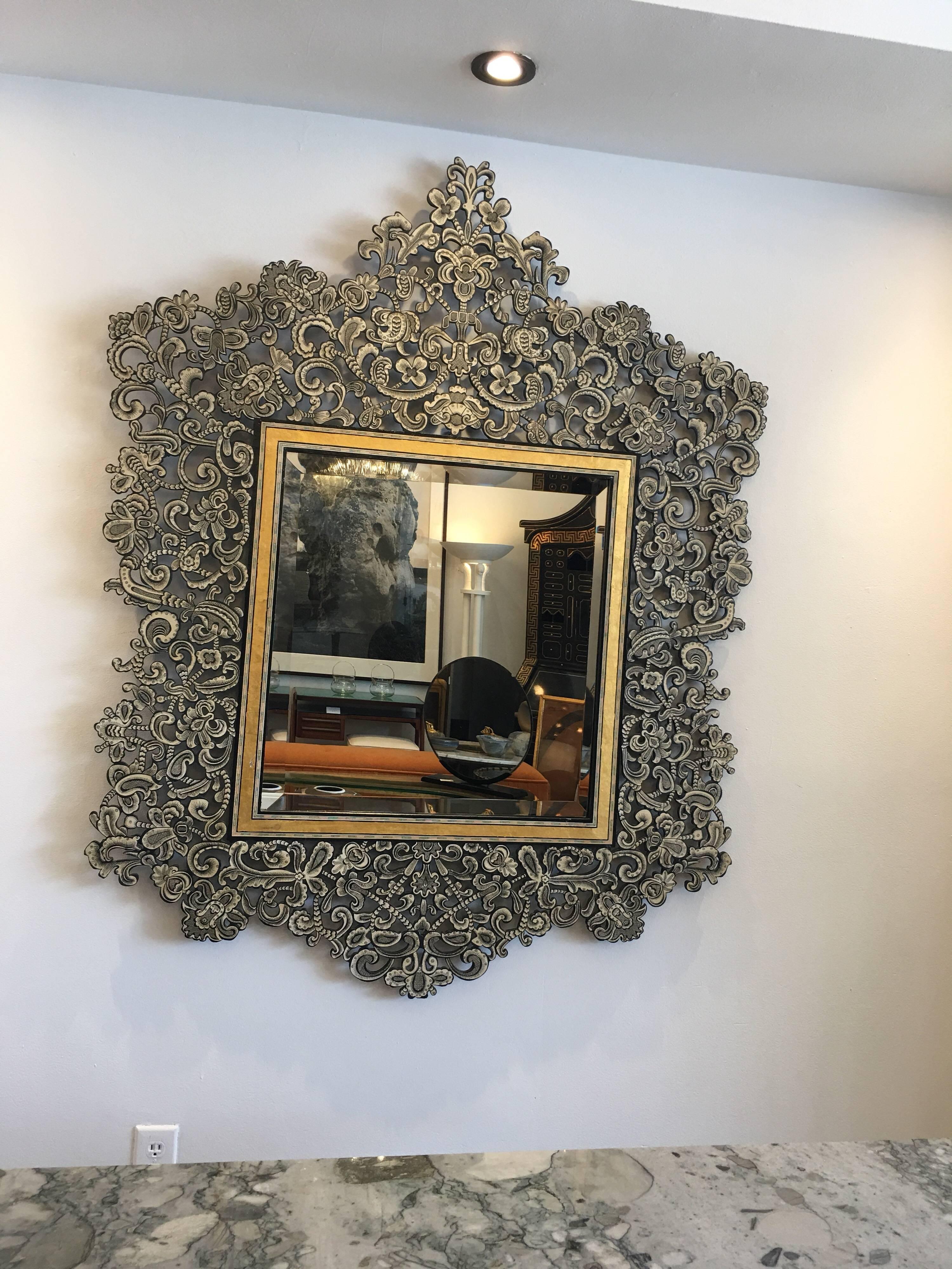 This elaborate stencil cut metal mirror with hand-painted applied paper overlay. Making this a striking statement - large in scale and highly decorative. Large bevelled mirror and gilt inlay framed mirror.