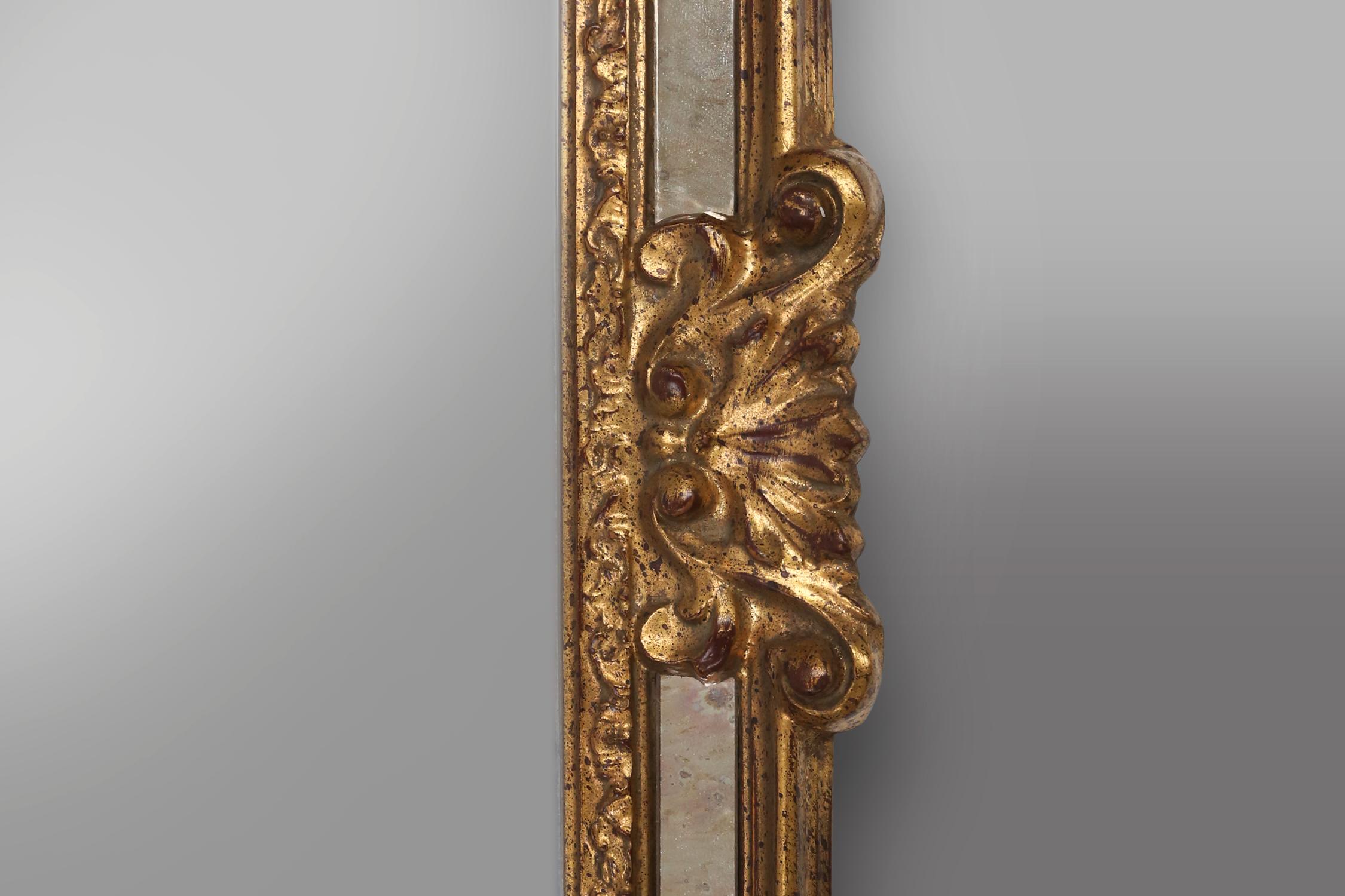 Mirror Large elegant gilted mirror with stunning ornamentation on the top, Deknudt  For Sale