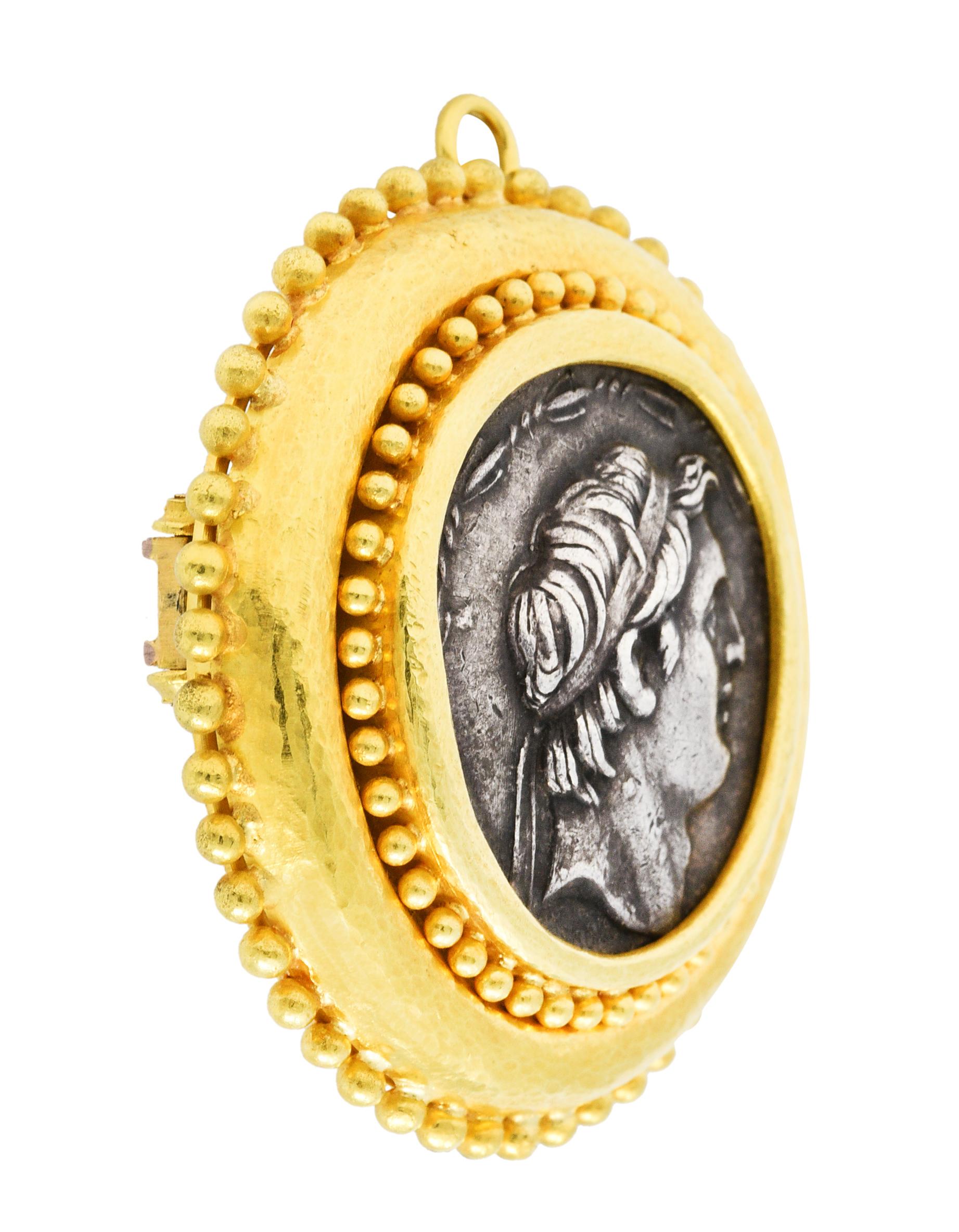 Substantial circular brooch features a silver tetradrachm coin

Front depicts the profile portrait of Demetrios I Soter of the Seleucid Empire

Back depicts Tyche, goddess of chance, seated and holding her icons - a bushel of wheat and a