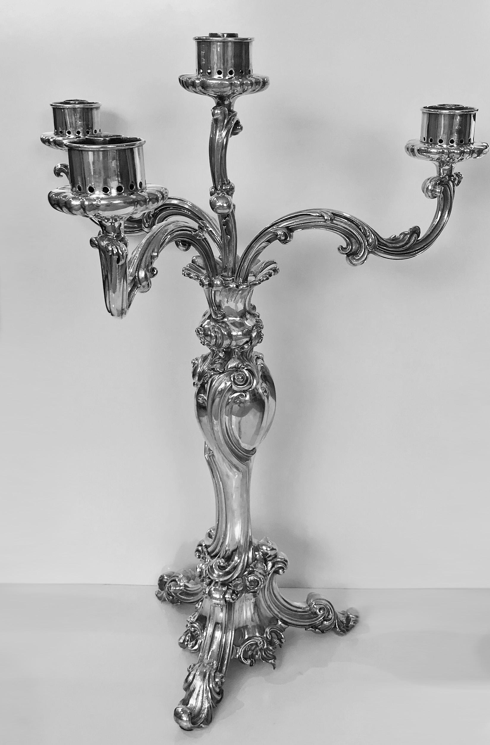 Rare early large Elkington Storm light centrepiece candelabra, England, 1844. The centrepiece baluster central stem supporting four detachable storm lamp fitting supports, all decorated in rococo style with scroll and foliage on a triangular