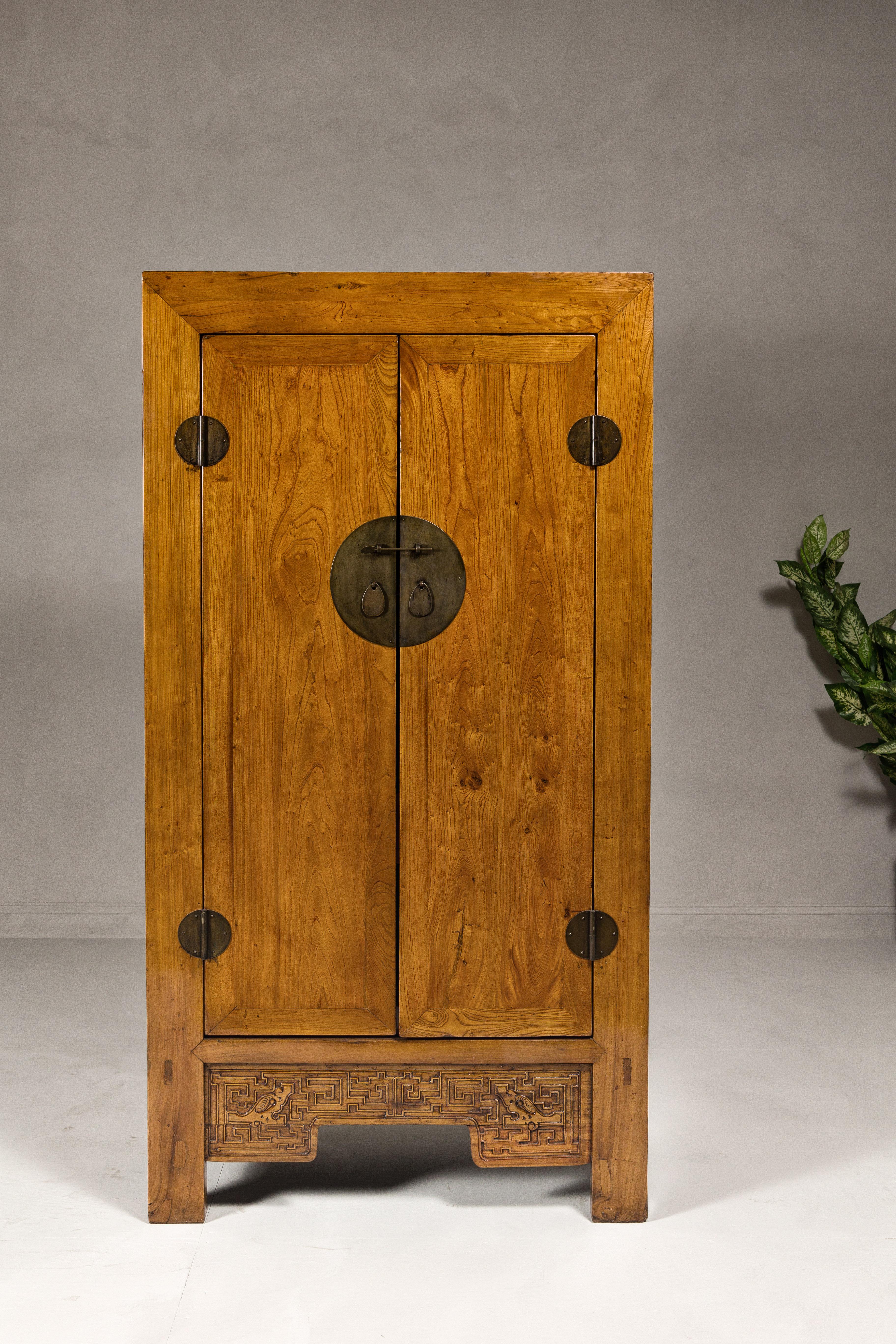 Qing Large Elmwood 19th Cabinet with Carved Apron and Round Brass Medallion For Sale