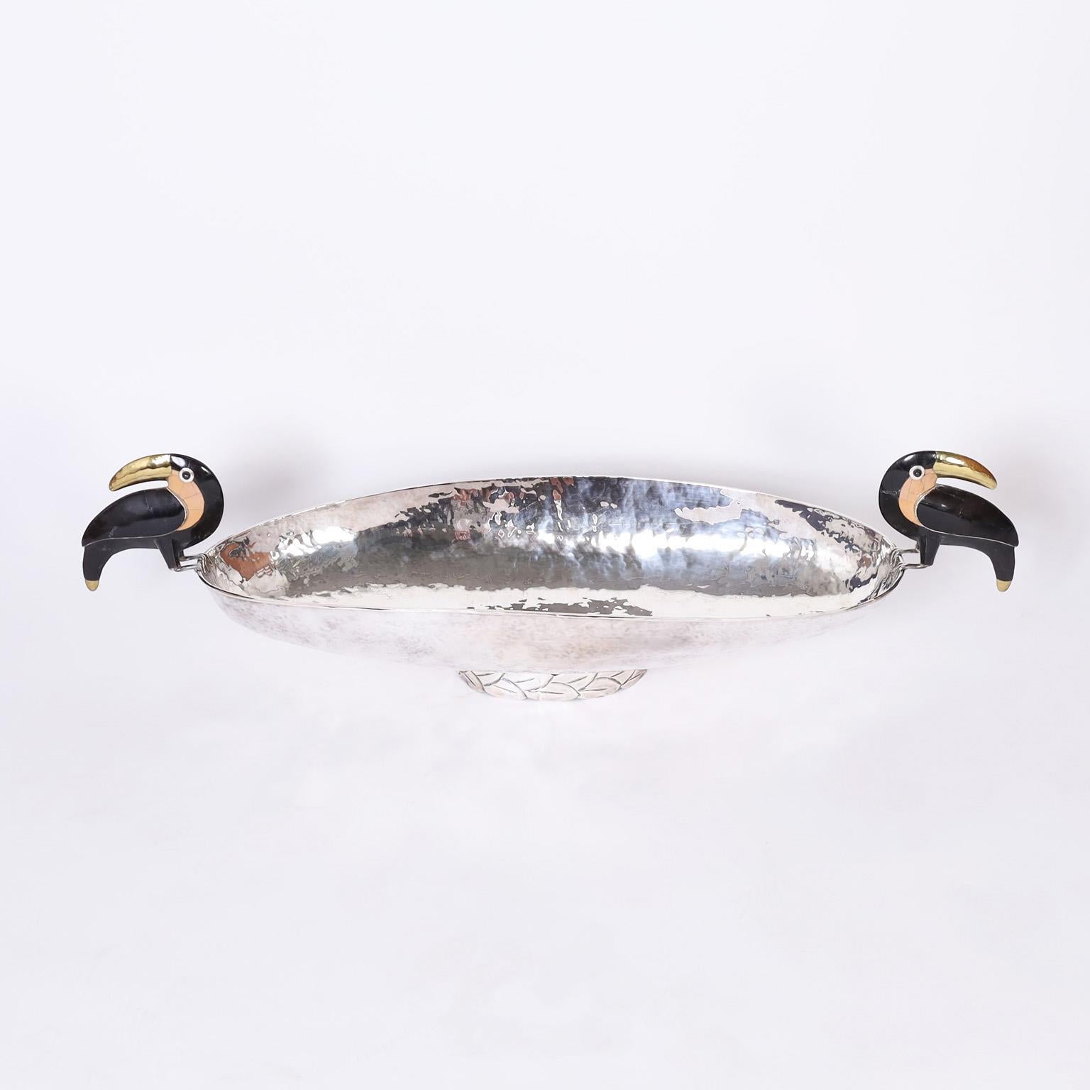 Large Eye catching bowl hand crafted in silver plate on copper with a dramatic art deco inspired form and featuring two stone clad toucans as handles. Stamped made in Mexico on the bottom.