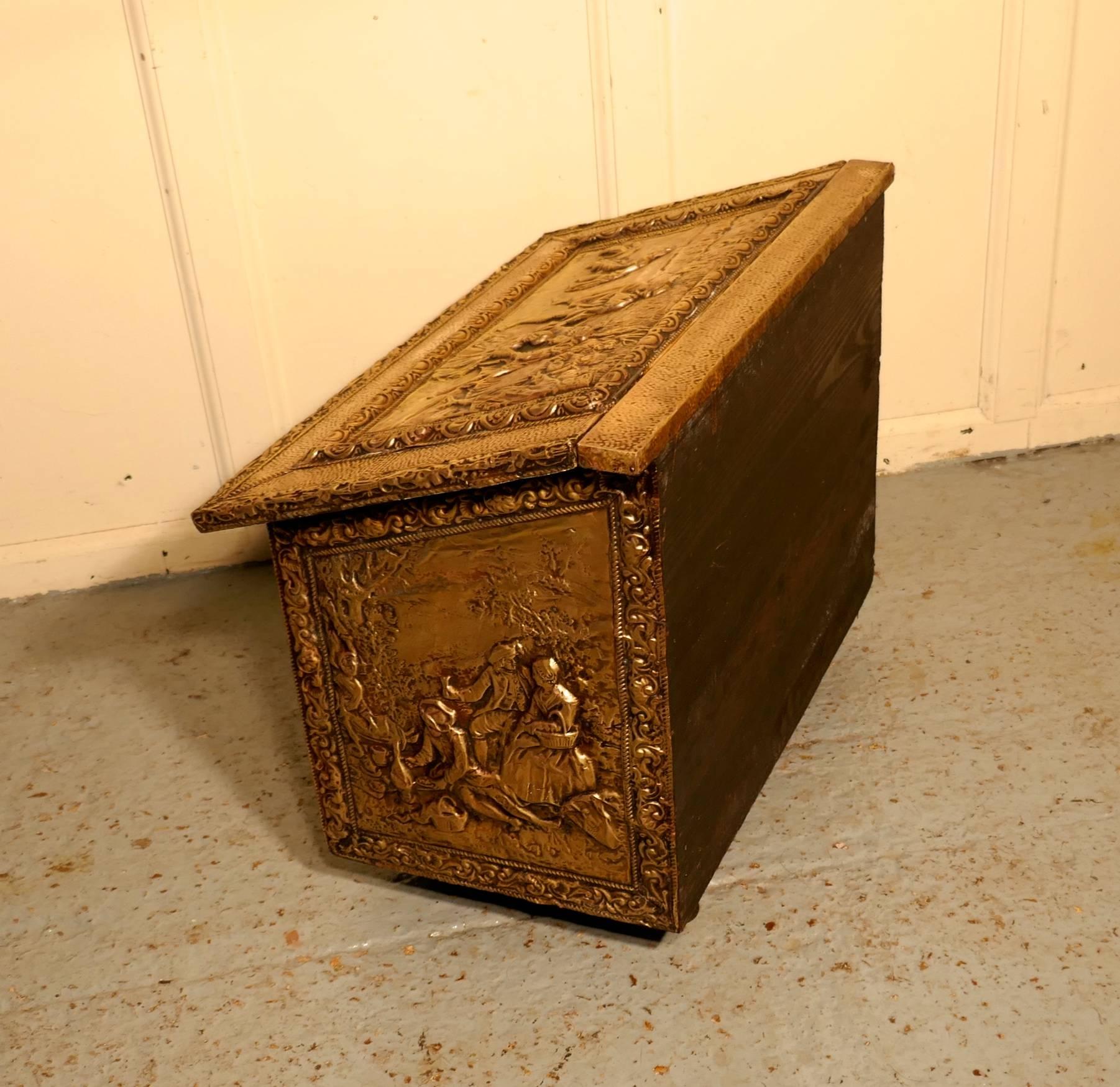 Large embossed brass log box, with country scenes 

This is a large chest is made in brass with a wooden lining, the beaten brass is embossed with country scenes, two of these have a signature in one corner
This is an old piece it has a very good