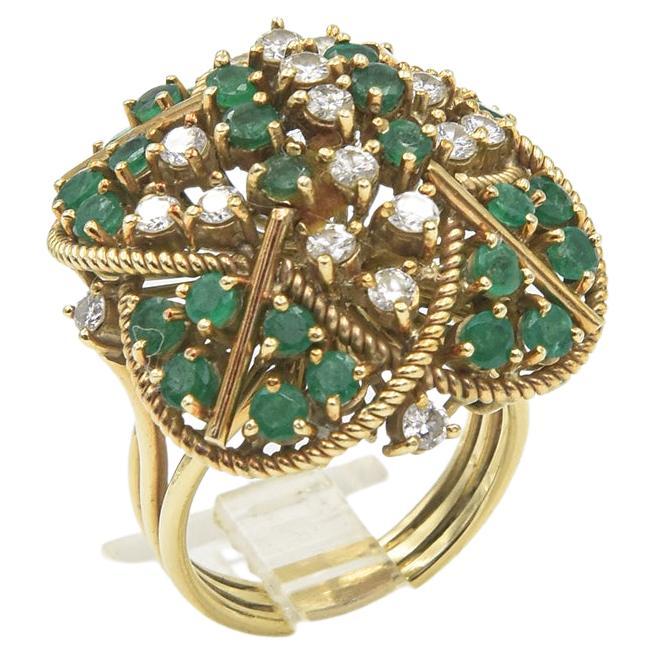 Impressive stylized emerald and diamond cocktail ring with twisted gold rope frame and gold bar accents.  The ring is made of 14k yellow gold and has prong set diamonds and emeralds.  It is a US size 7.25,  It measures 1.03