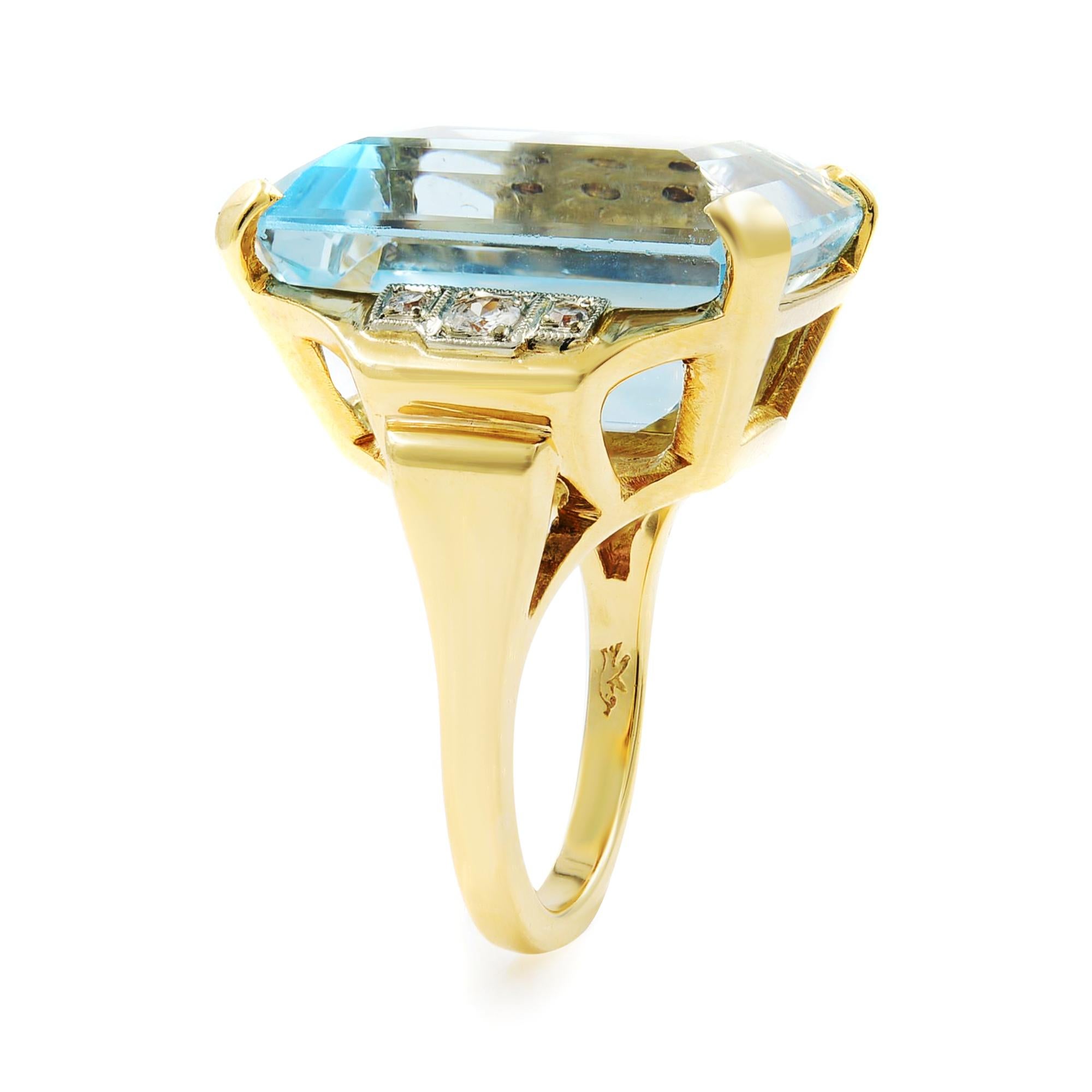 This is a beautiful large emerald cut aquamarine ring with diamonds on both sides. Total diamond weight is 0.25ct with G-H color, VS-SI clarity. Aquamarine weight: 23.76 carats.  Crafted in 14k yellow gold. Ring size: 6.5. Total weight: 15.83 grams.