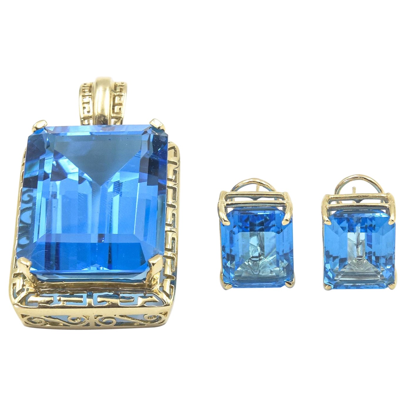 Großer Anhänger aus Gelbgold mit blauem Topas im Smaragdschliff und passenden Ohrringen