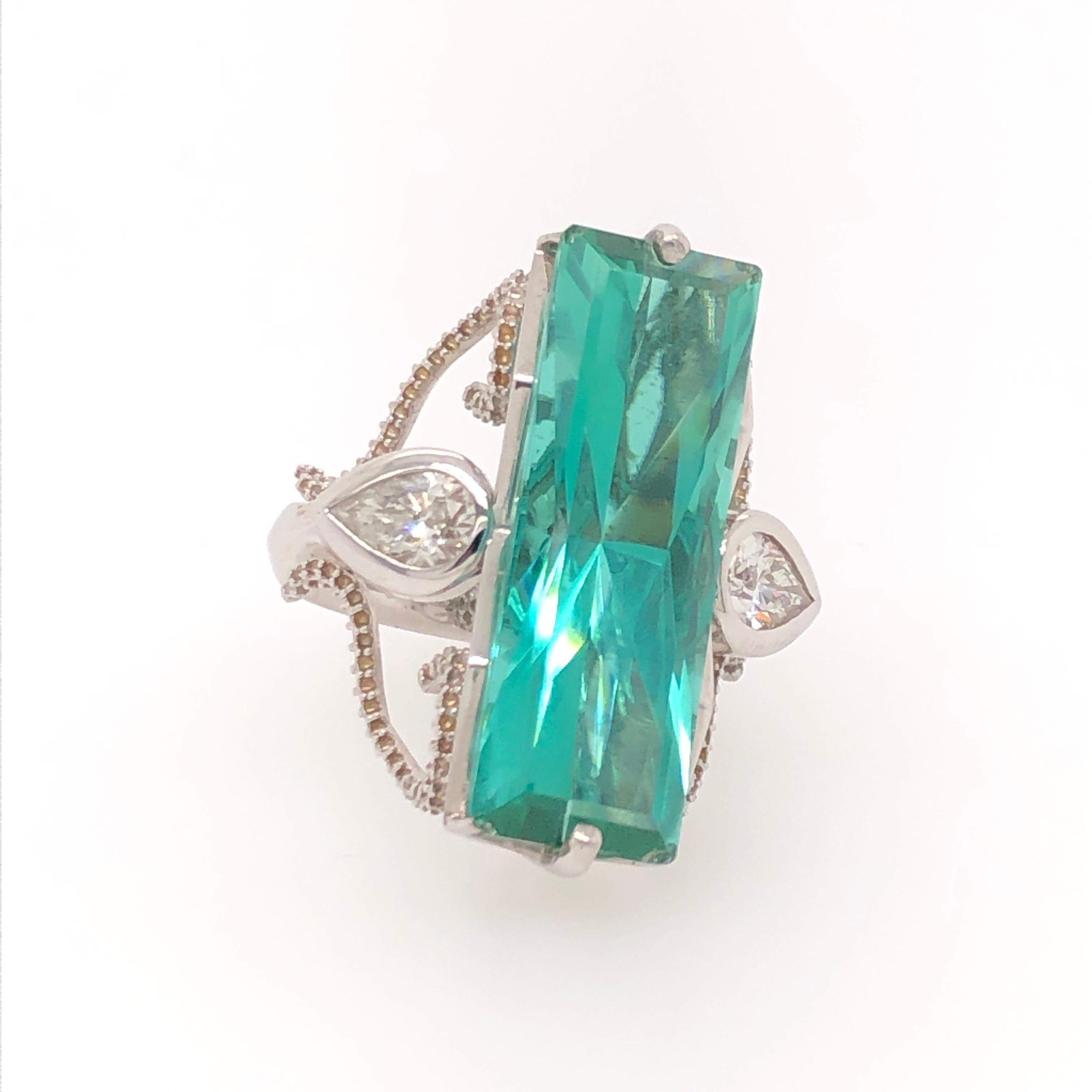 Where most teal tourmaline of this impressive size have copper in them, this extremely rare teal Afghan tourmaline is flawless. Master level artist, Trent Mann, designed the unique and beautiful 14K white gold ring in addition to cutting the 11.96