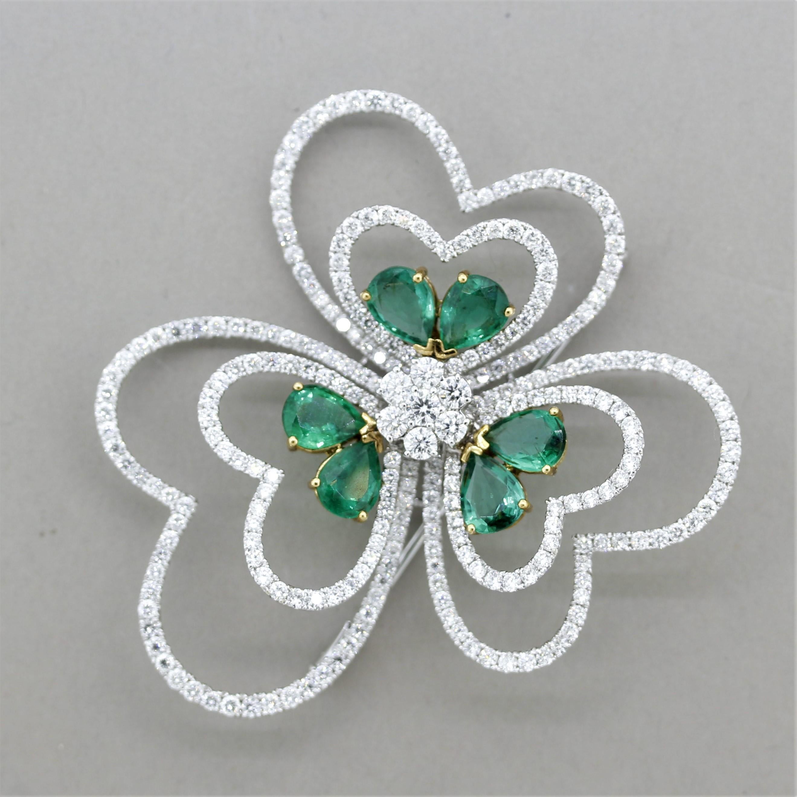 A stylish brooch full of love! It features 5.70 carats of pear-shaped emeralds. Adding to that are 5.59 carats of round brilliant-cut diamonds, cluster-set in the center of the flower as well as on the outer heart petals. Large but light enough to