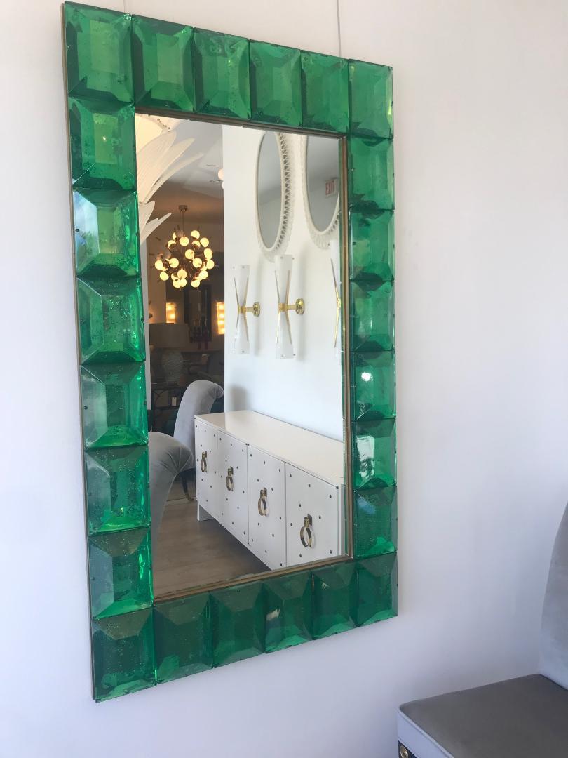 Large emerald green Murano glass and brass frame mirror.
Each emerald green glass block has a highly polished diamond faceted cut pattern with air inclusions throughout. Can be displayed either horizontally or vertically.
Weight is 158 lbs.