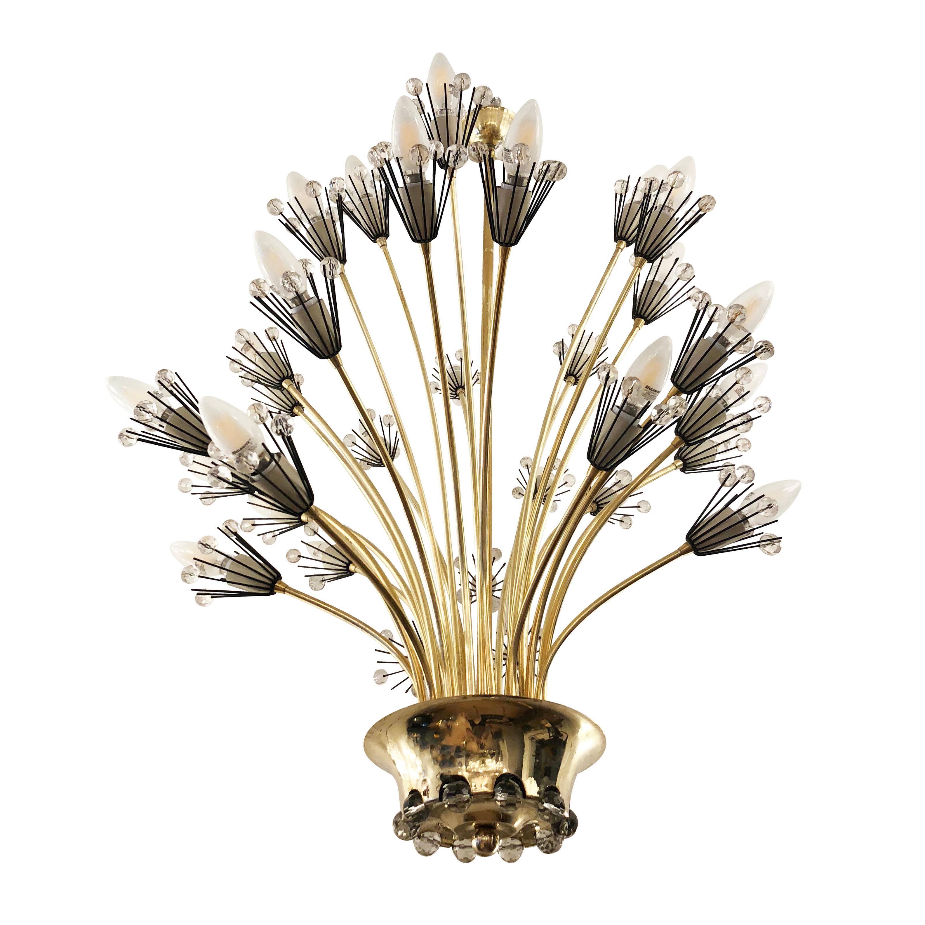 Charming Austrian chandelier designed by Emil Stejnar for Rupert Nikoll in the 1950s. Features 30 brass arms of different lengths ending in a black and white “blossom” decorated with crystals. The hub also lights up thanks to three concealed lights.