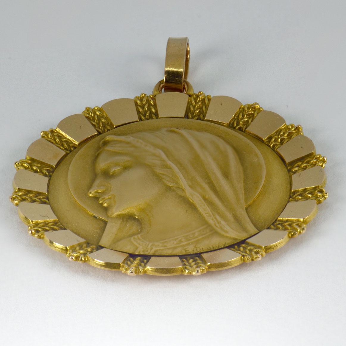 An 18 karat (18K) yellow and white gold pendant designed as a medal depicting the Virgin Mary with a sunburst pattern surround. Engraved to the reverse with a monogram of BB and the date ‘1 Julliet 1962’.  Signed E. Dropsy, stamped with the eagle’s