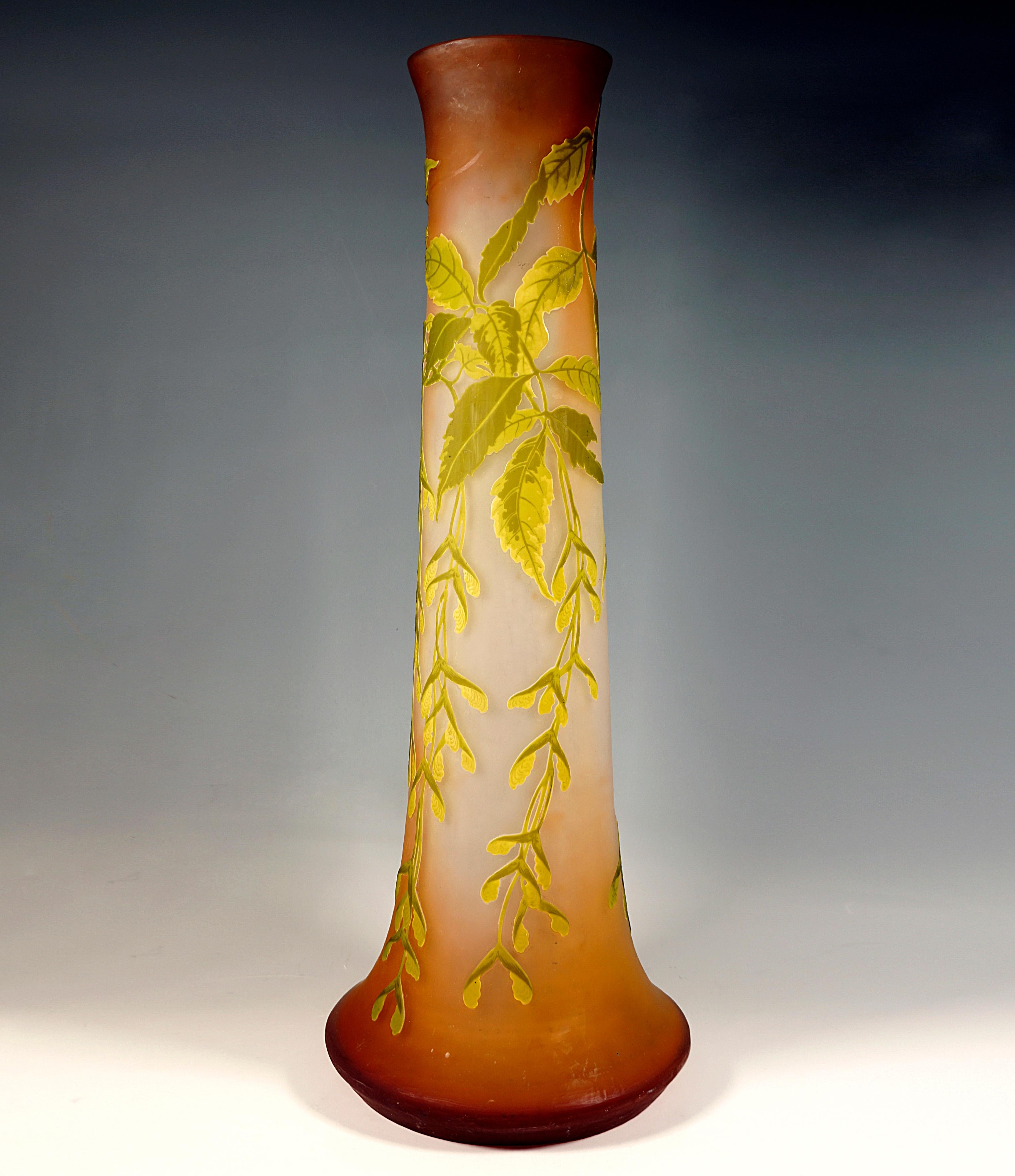 Large vase on a round stand, widening like a bulge and then narrowing to a slightly conical, long, wide neck, opening with slightly flared mouth rim, colourless glass with orange-brown colour powder fusions, overflows in yellow and green, highly