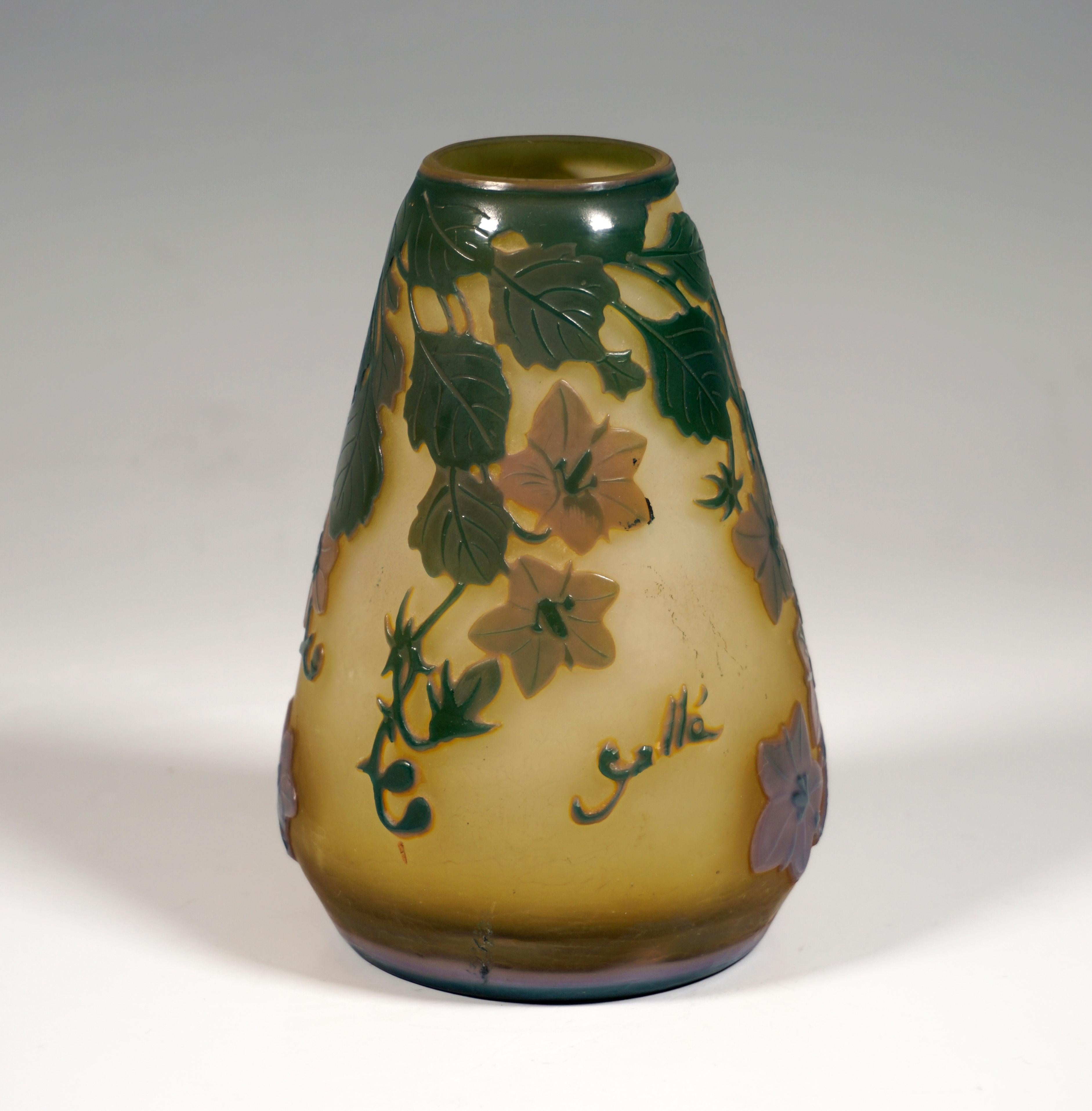 Vase in a exceptional conical shape, colorless glass with yellow colored powder inclusions, overlays in lilac and green, in various stages highly etched decoration with clematis blossoms and leaves, etched matt on the inside and background on the