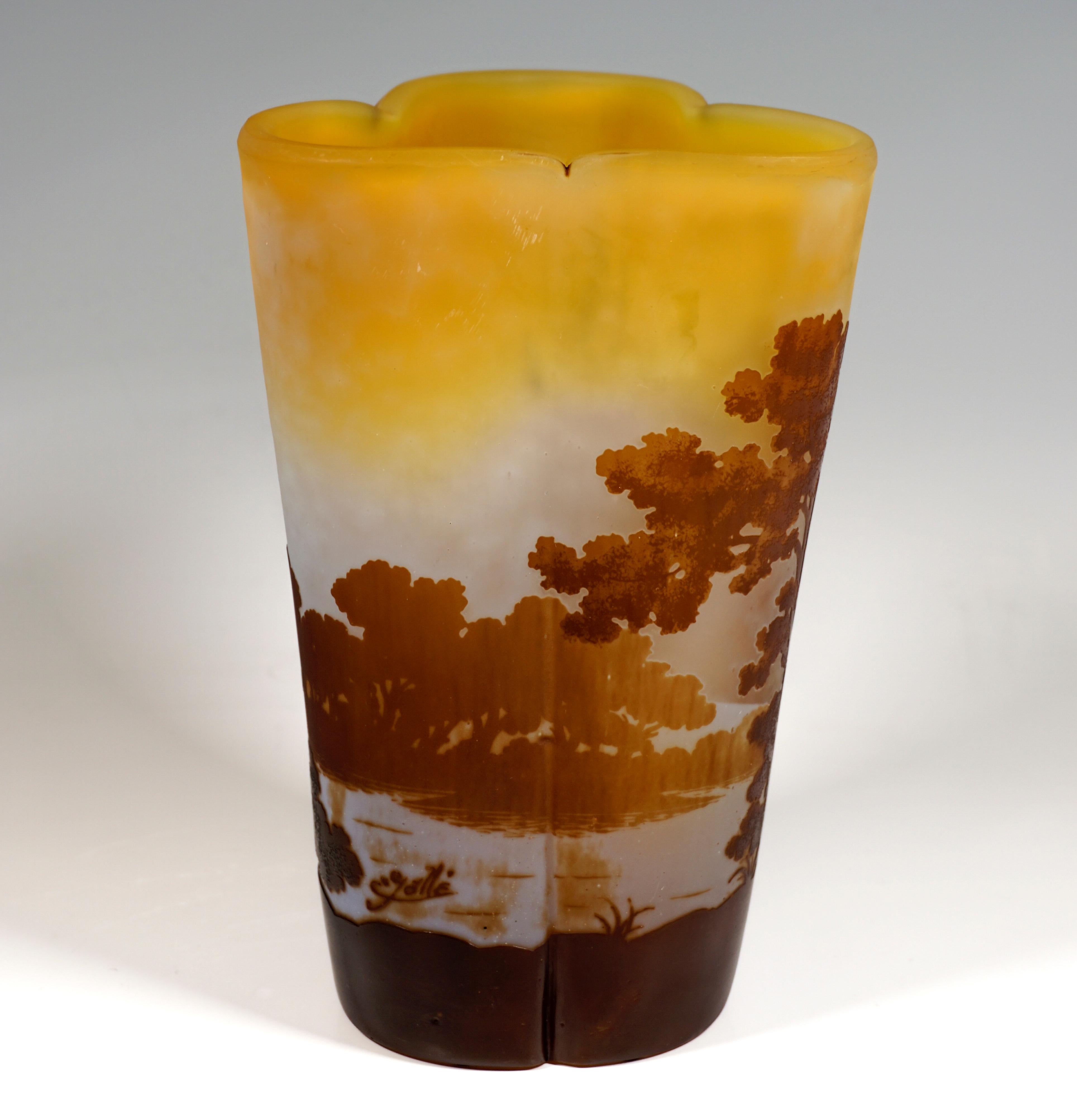 Vase with a three-pass floor plan, widening upwards, dented at the upper edge between the segment arches, outer edge ground at the top. Colorless glass with yellow-orange color powder inclusions in the area of the base and on the upper edge,