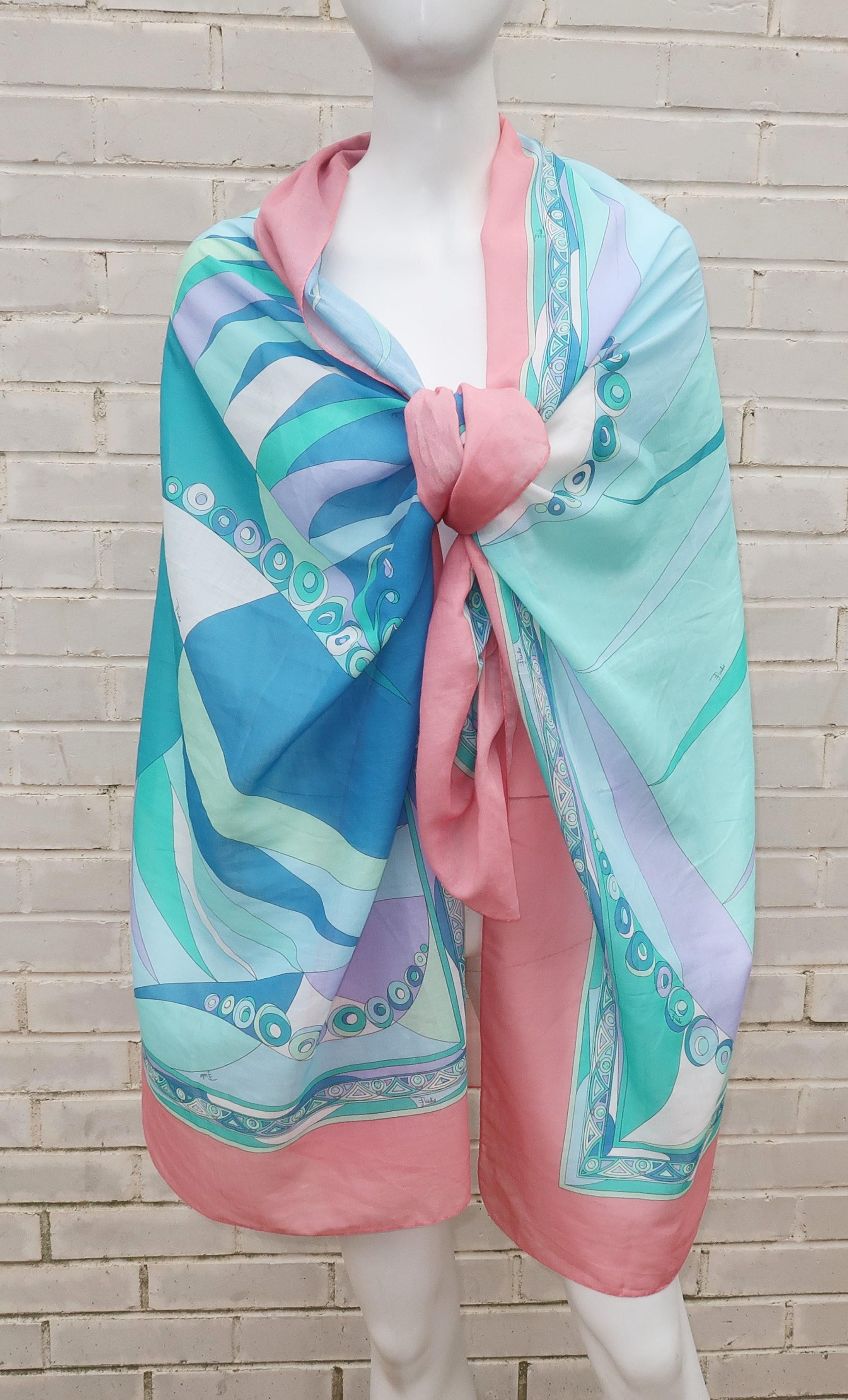 Perfect for warmer weather and sultry days at the beach! This fine muslin cotton Emilio Pucci scarf is both long and lightweight enough to wrap and drape to your heart's content. It is a classic mod psychedelic print in shades of salmon pink, aqua,
