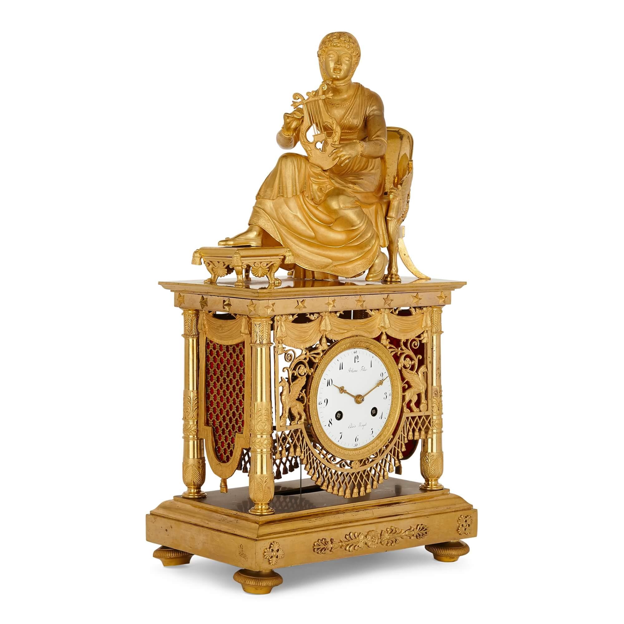 Large Empire period gilt bronze mantel clock
French, early 19th Century
Measures: Height 52cm, width 28cm, depth 17.5cm

This superb Empire period mantel clock is crafted form gilt bronze. The clock features a large surmount of Erato, the Muse