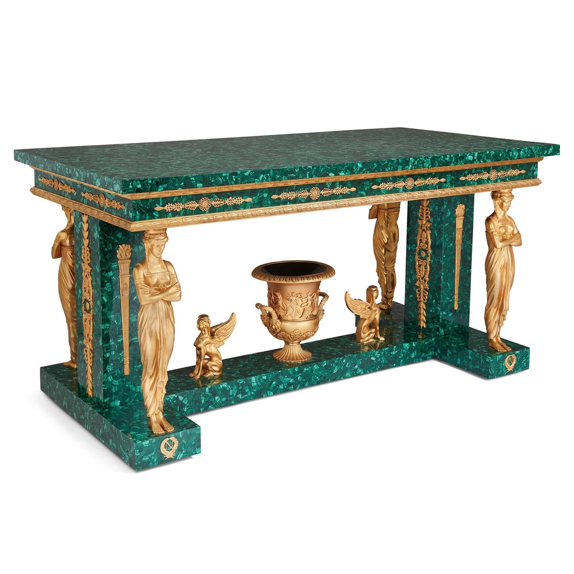 Large Empire-style ormolu and malachite centre table 
French, 20th Century
Height 85cm, width 165.5cm, depth 85.5cm

This superb centre table pairs vibrant malachite with classical ormolu mounts. The malachite tabletop sits atop a recessed malachite