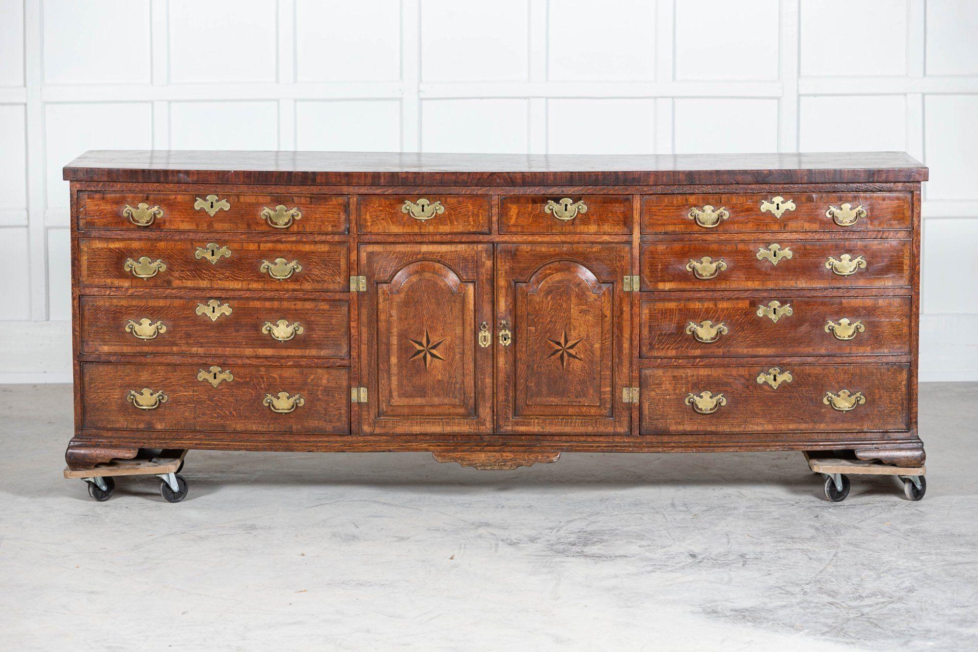 Circa 1720.
Large English 18thC George I oak dresser base with graduated drawers and fielded panel doors.
An exceptional example.
Lightly restored.
Measures: W 222 x D 52 x H 78cm.
 