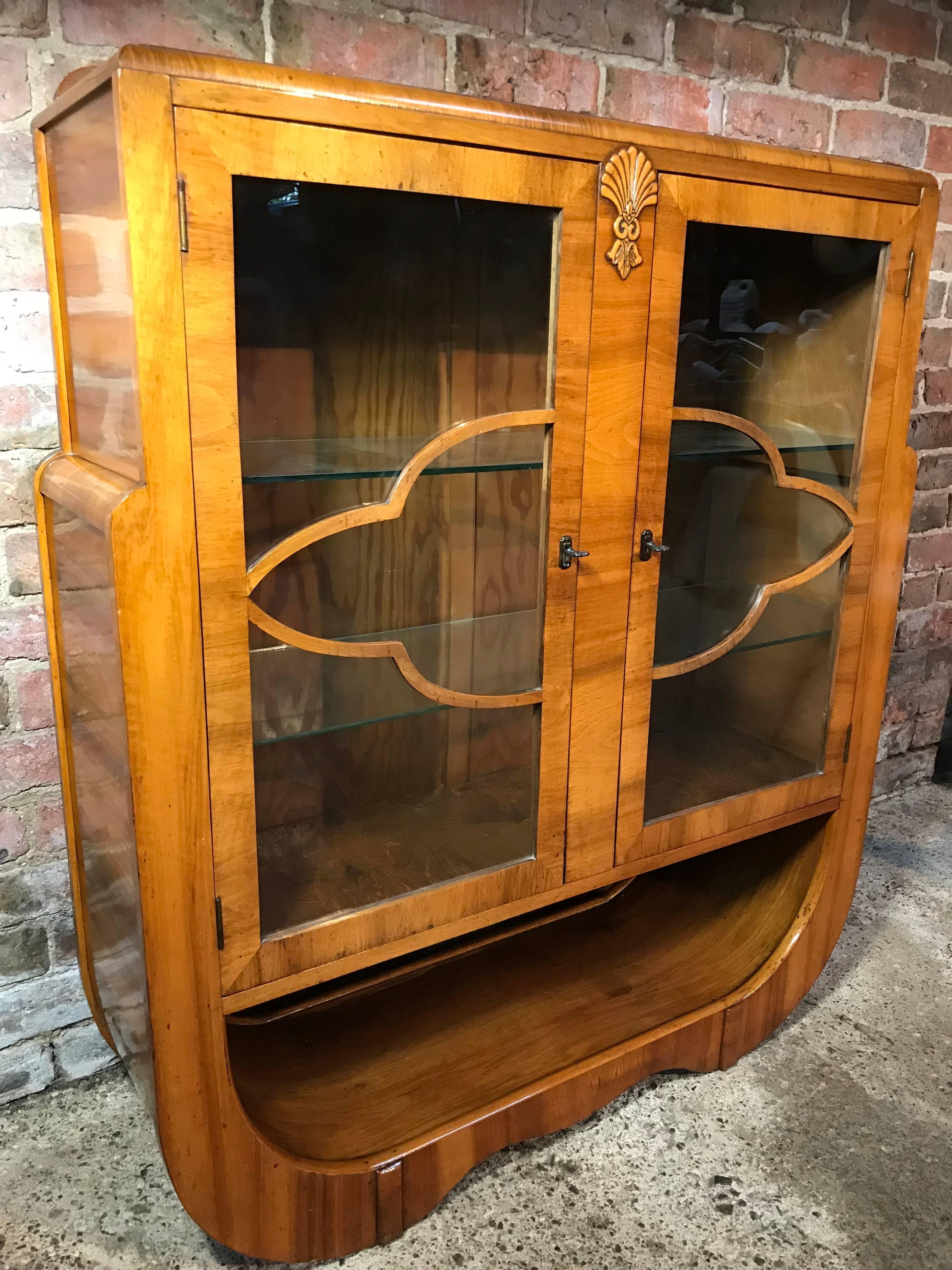 Large English 1930 Art Deco walnut display cabinet in mint condition, it comes with two inturnal glass shelves and a shelf space underneath the main cabinet. It is supplied with two keys.