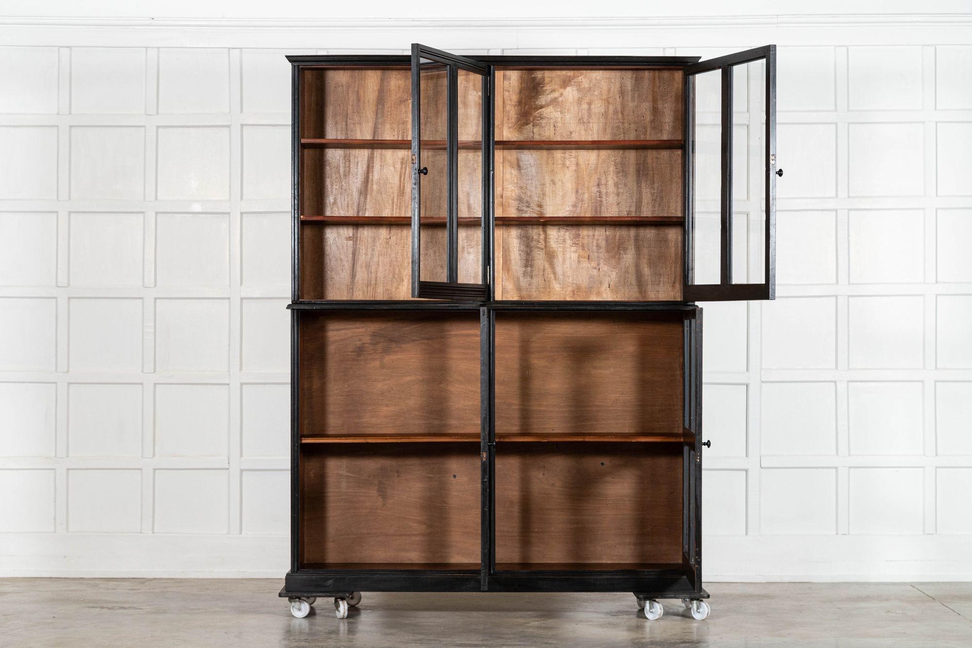 circa 1880
Large English 19thC Ebonised Mahogany Glazed Cabinet

sku 2059
Together W169 x D36 x H217
Top internal shelf depth 30cm
Bottom internal shelf depth 29cm
Weight 115kg
Shipping Dimensions
Top W169 x D36 x H101 Weight 52kg
Bottom W168.5 x