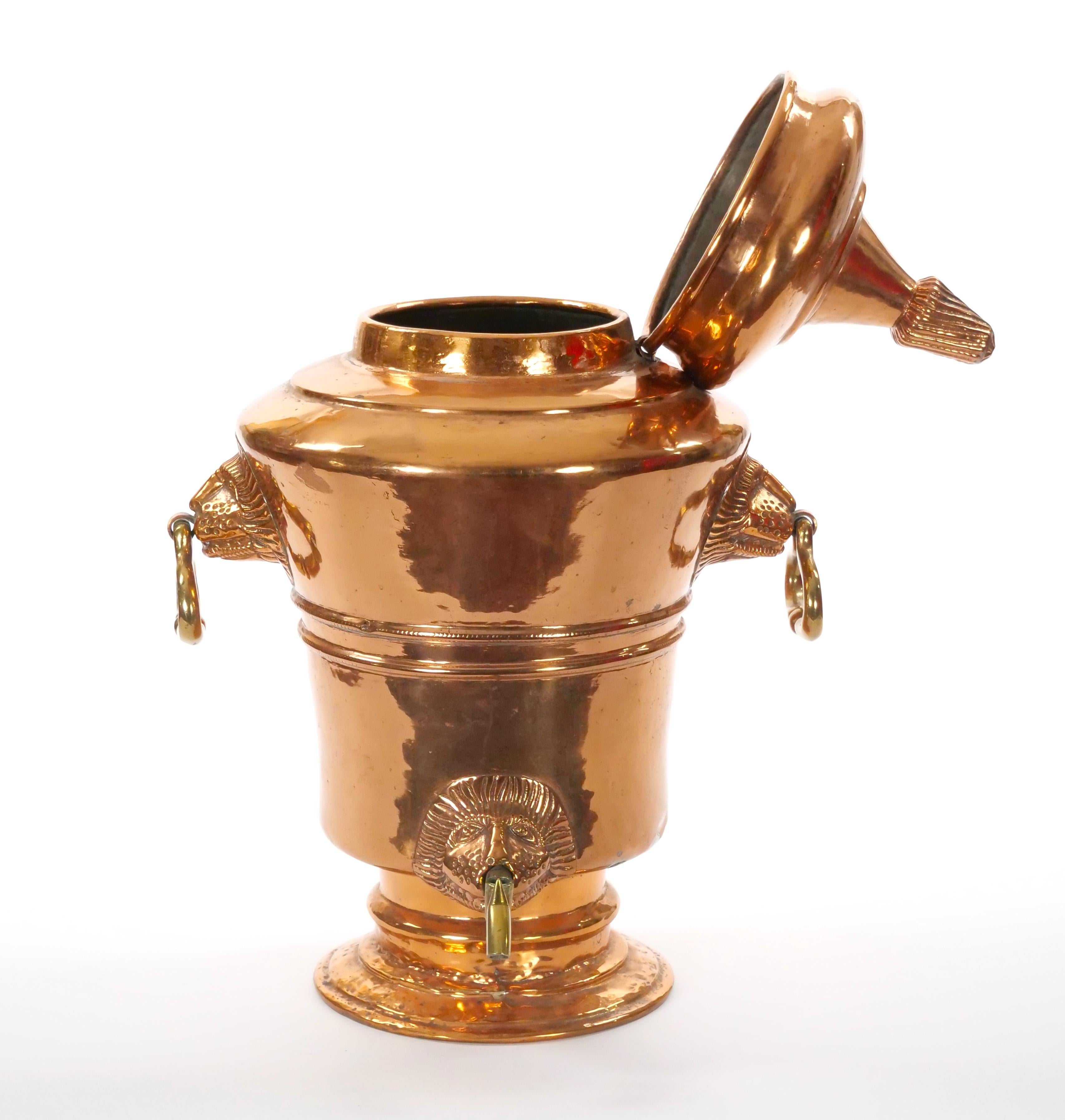 This impressive large English urn, crafted from copper in the mid-19th century, is a testament to the exquisite craftsmanship of the era. The urn features a prominent raised hinged lid adorned with intricate decorative relief designs, adding a touch