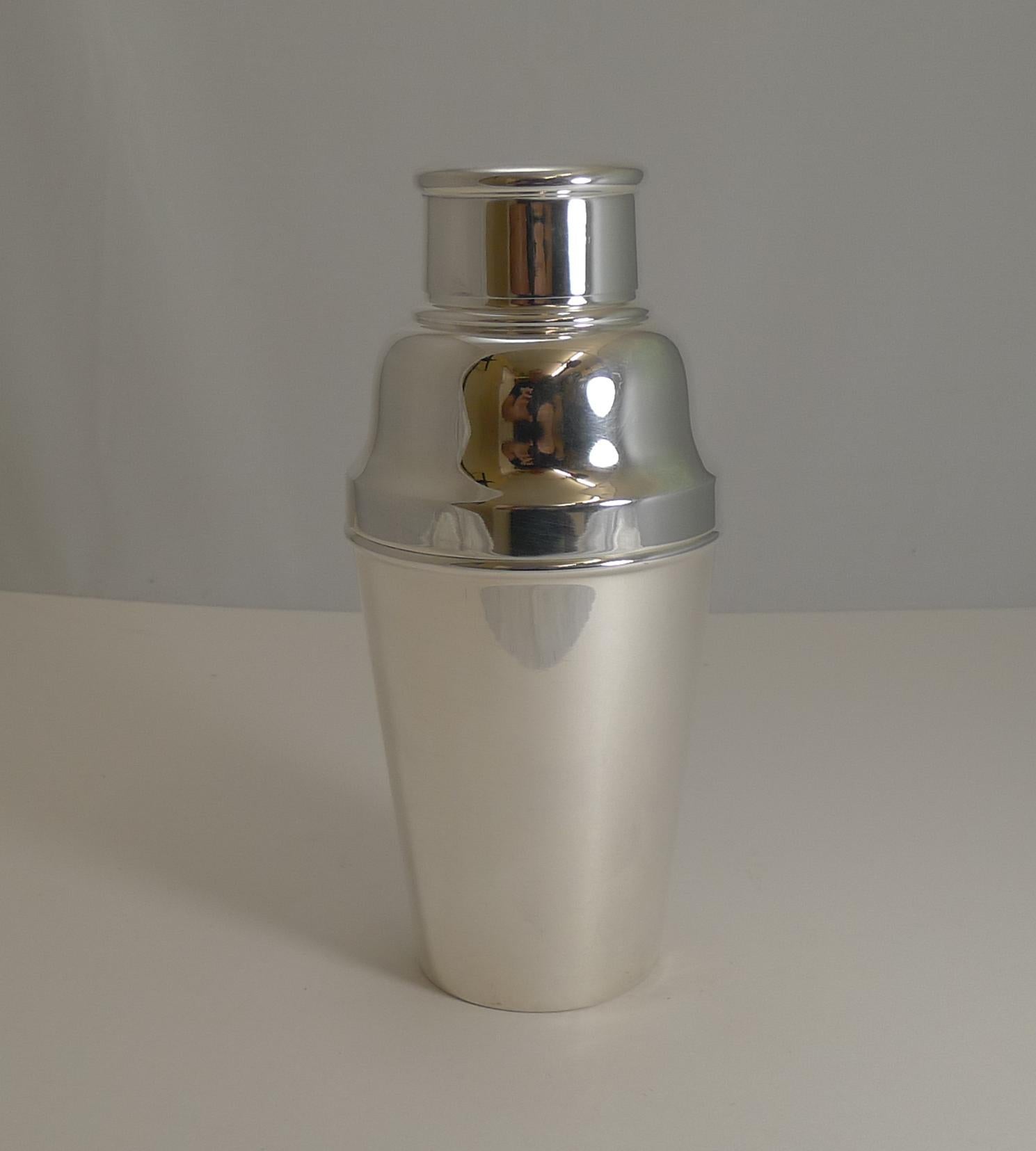 A wonderful large sized one and a half pint cocktail shaker in silver plate. Highly desirable, this one has an integral ice breaker which is revealed once the upper portion is removed.

The underside is signed by the silversmith William Suckling