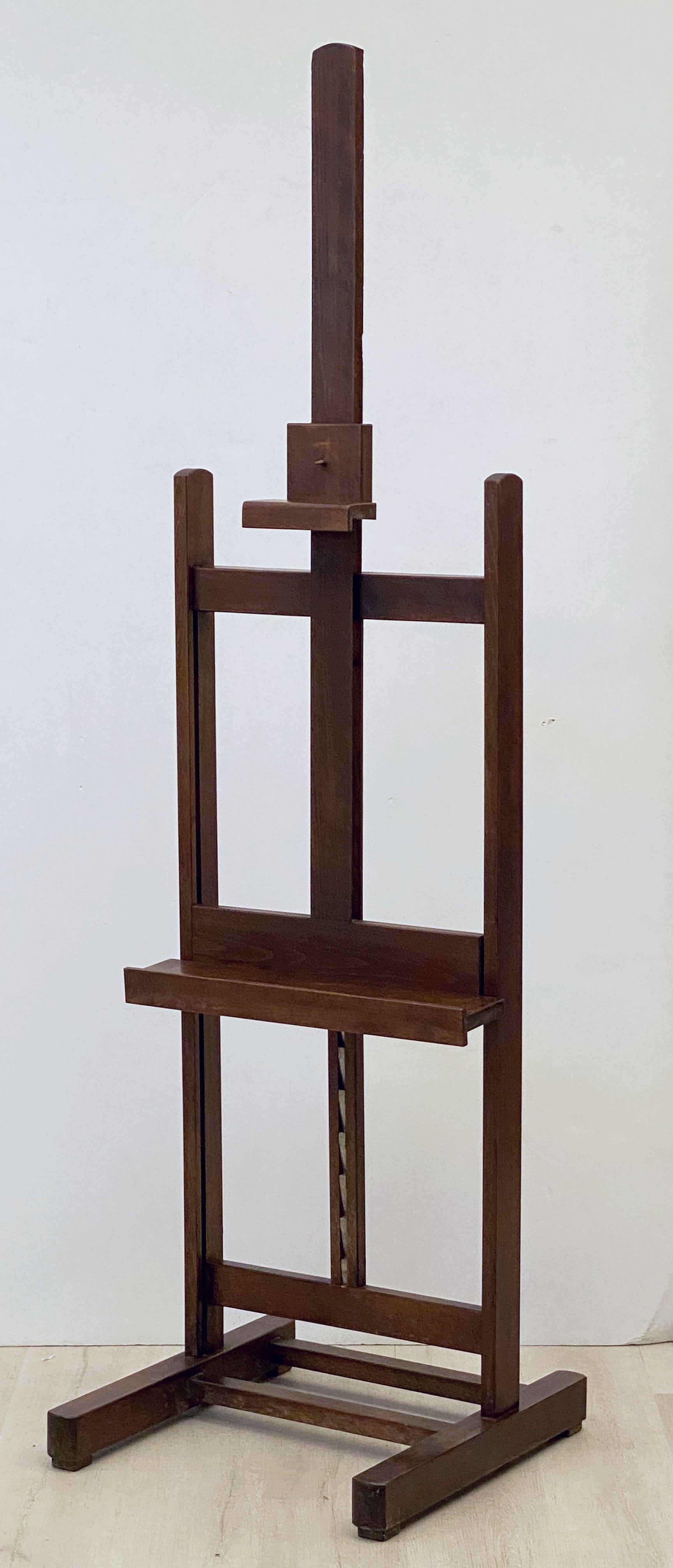 A handsome English artist's display or studio floor easel from the early 20th century, featuring a spring latch to adjust the tray height, solid beam construction, on rolling casters.

This sturdy easel can handle large canvases or function as an