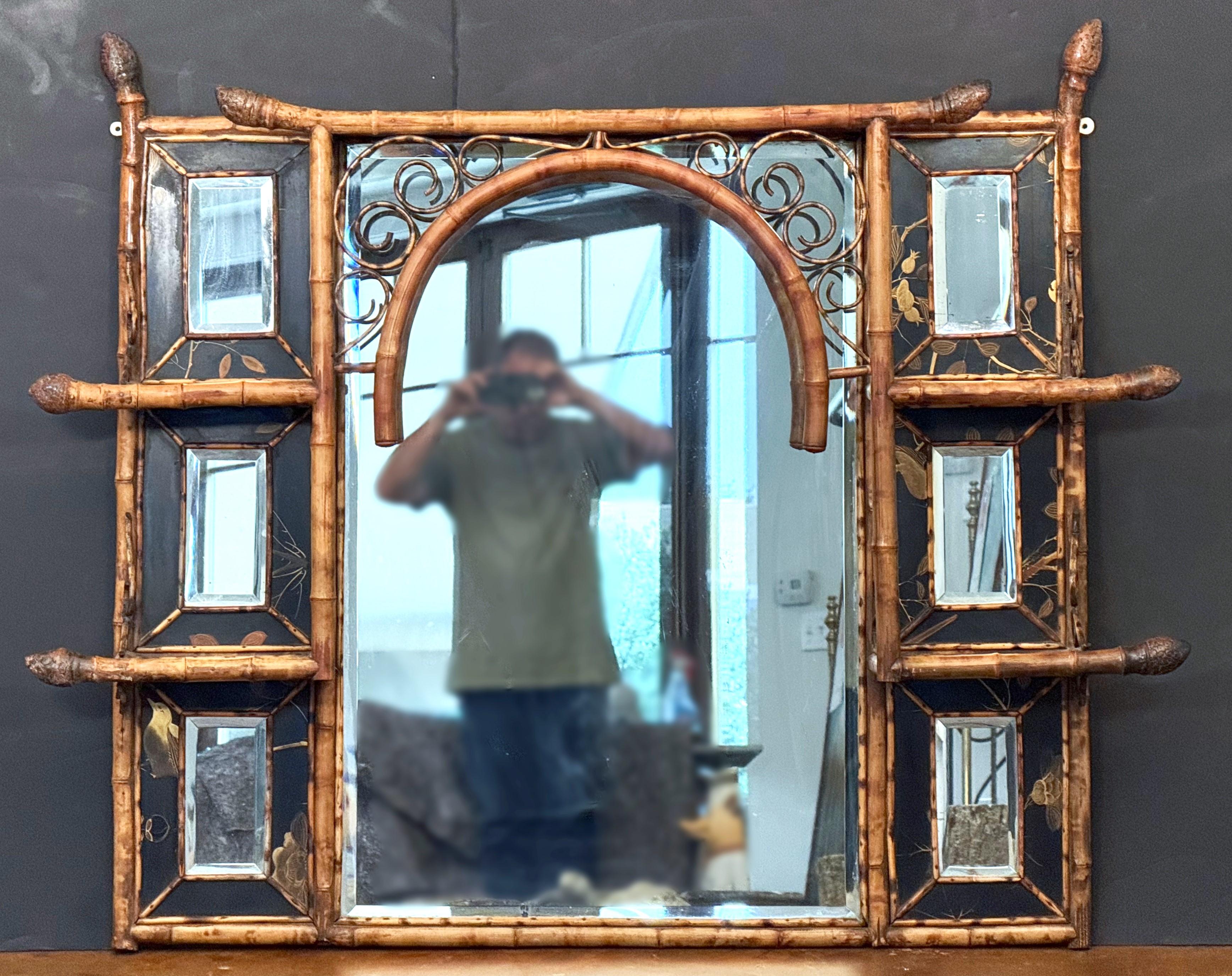 A fine English bamboo over mantel or wall mirror with a period Aesthetic Movement design, circa 1870-1910, featuring a bamboo frame with lovely bamboo fretwork around the circumference, a large rectangular portrait mirror surrounded by an opposing