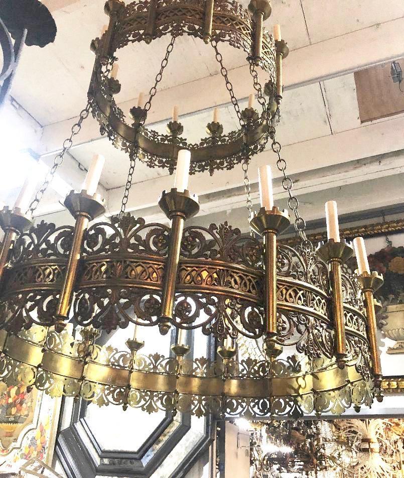 A large circa 1930's double-tiered thirty-light English chandelier with intricate foliage motif decoration and openwork on bronze body.

Measurements:
Diameter: 42