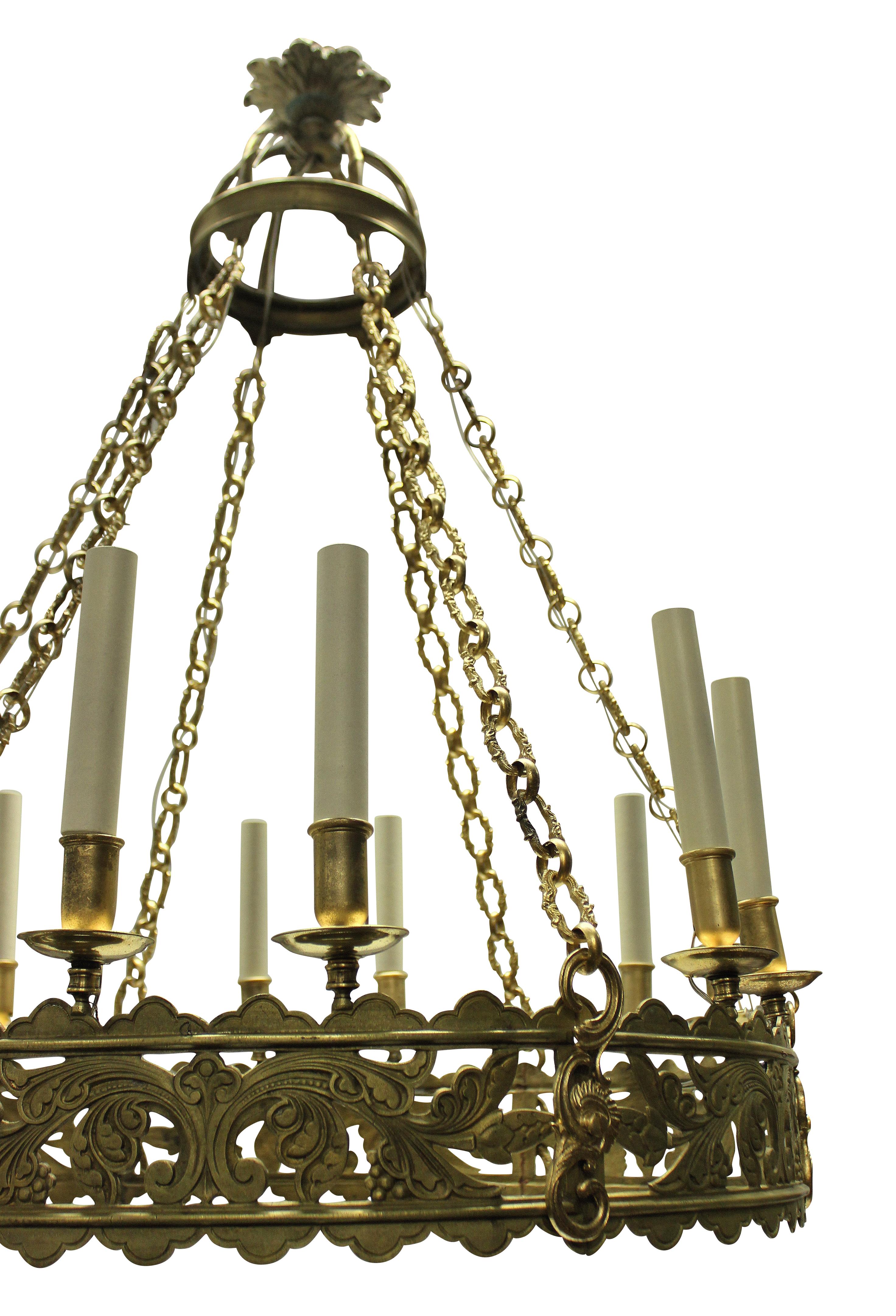 A large English corona chandelier in the Gothic manner. Finely worked in gilt brass, with twelve-light.