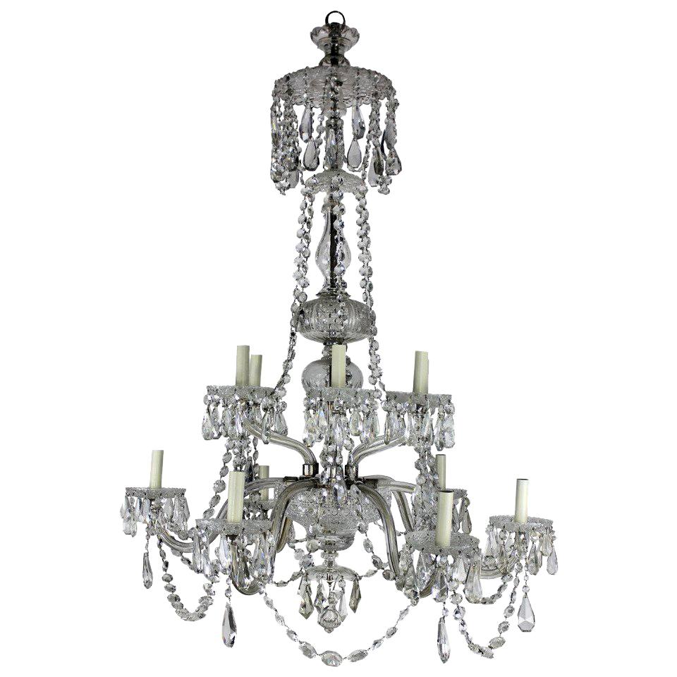 A large English cut-glass chandelier of good quality. Of six down-swept and six up-swept arms, decorated heavily with swags and pendant drops.