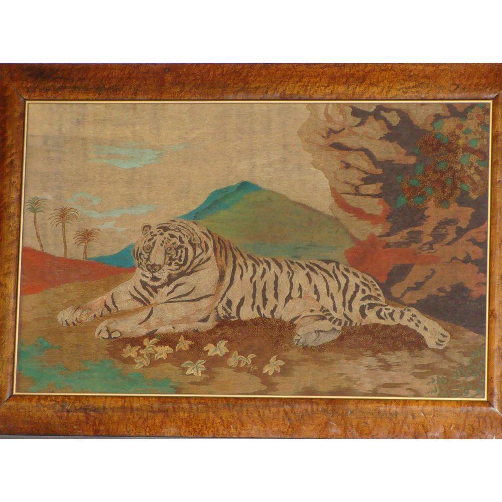 A large English early 19th century Primitive picture of a tiger in a landscape. Circa 1820.
From the naive English school.
The recumbent tiger hand-worked in colored wools below a mountain with palm trees and tropical foliage.

This highly