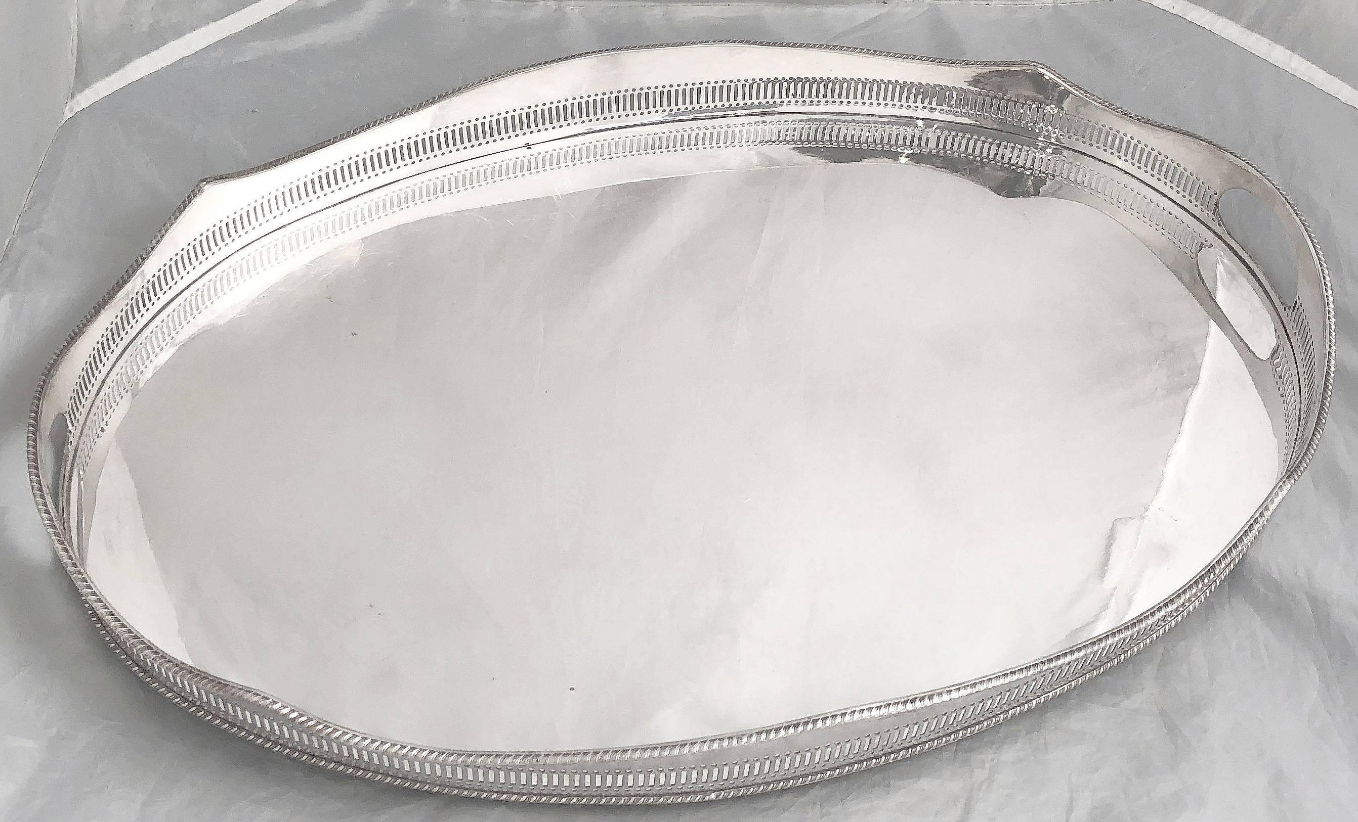 A handsome large English oval gallery serving tray with pierced serpentine gallery around the circumference. Of fine English plate silver.

Dimensions: Gallery H 2 1/4