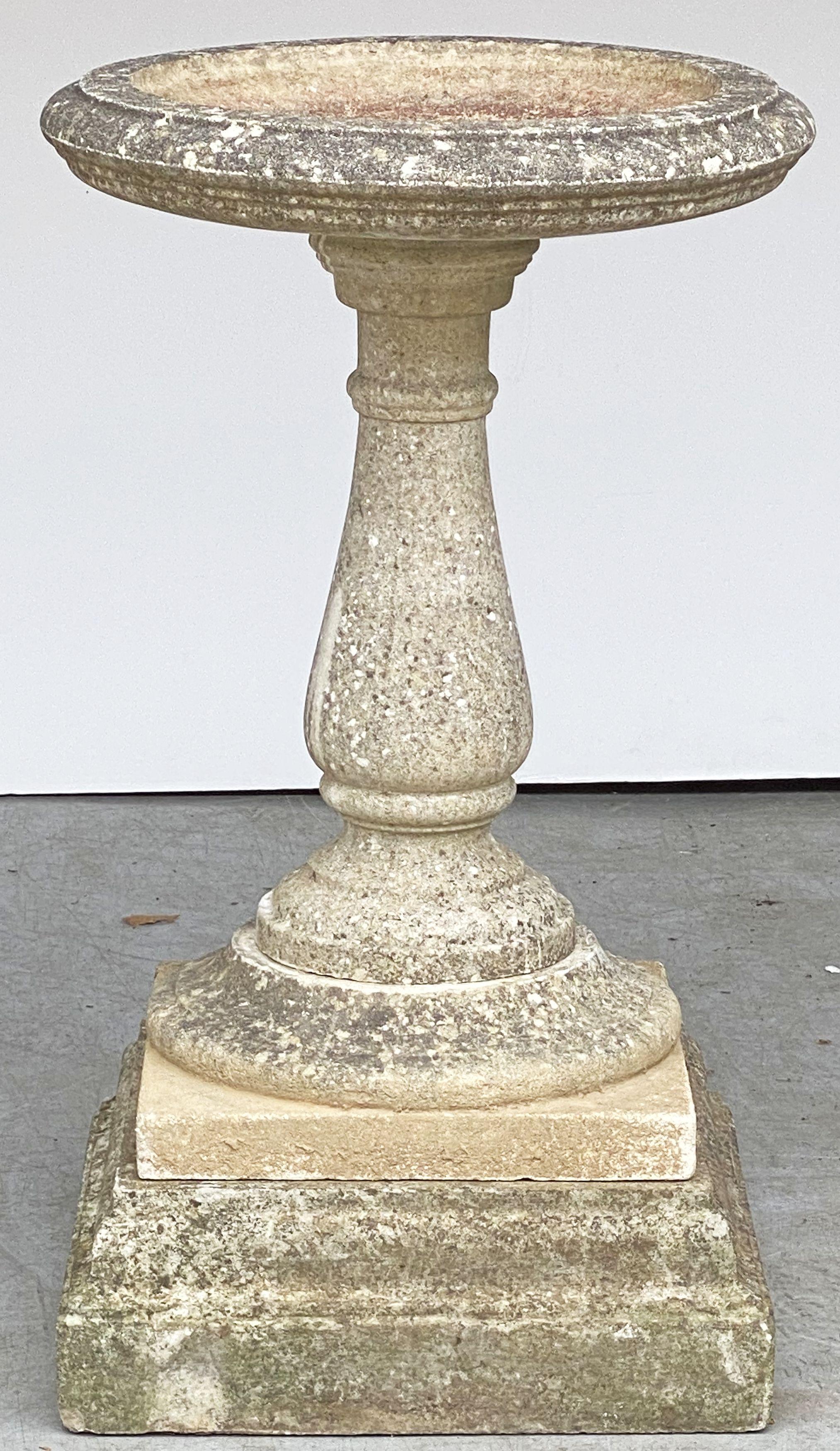 A handsome large English bird bath (or birdbath) of composition stone, featuring a 21 inch diameter basin top (circular) set upon an elegant Neo-classical baluster pedestal column and raised square plinth base.

Breaks down into four pieces for