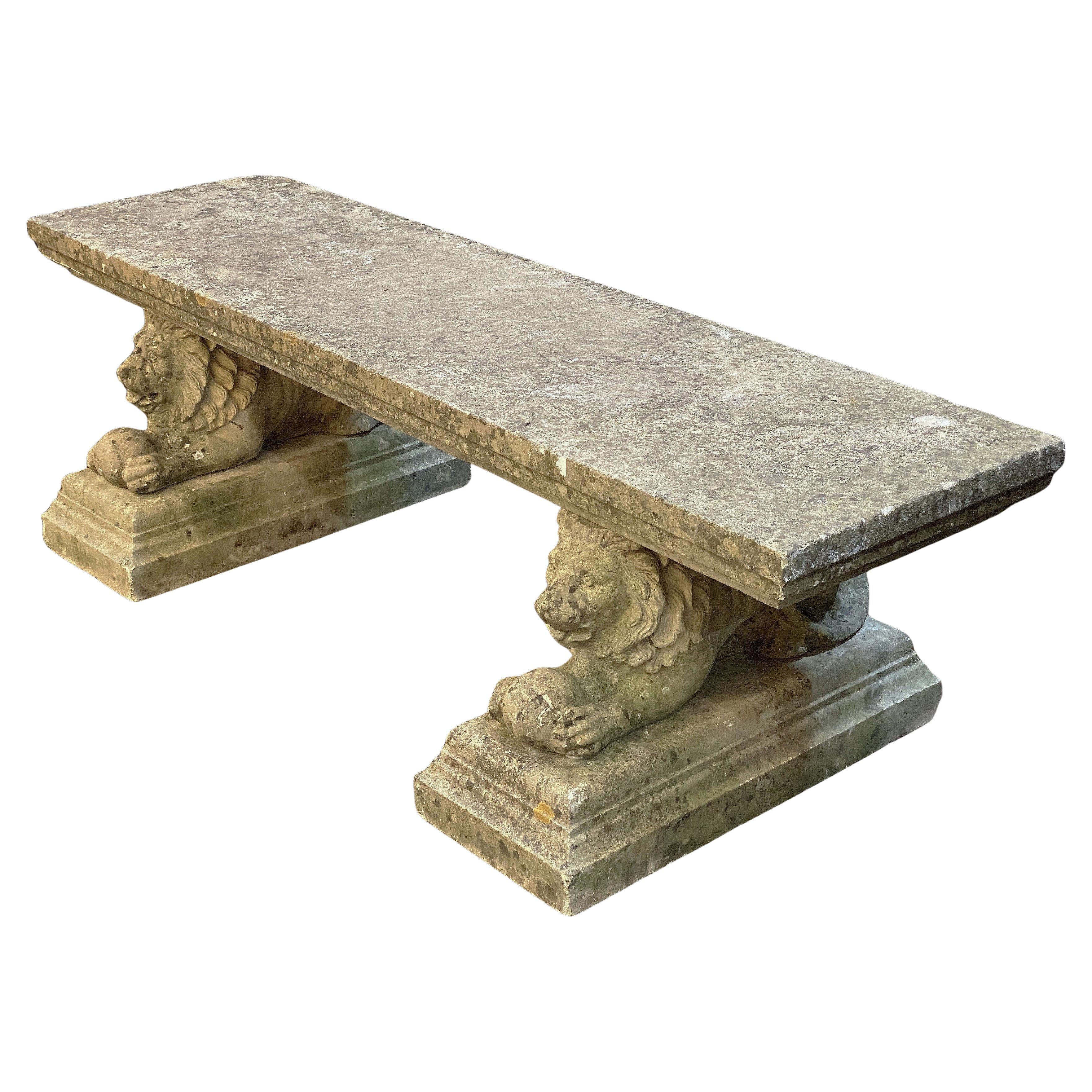 A handsome large English garden long bench or seat of composition stone, featuring a rectangular plank top set upon two recumbent lion on plinth supports. 

Note: top is removable from base.

Dimensions: 
H 19 3/8 in
W 65 7/8 in
D 26 in

Great for