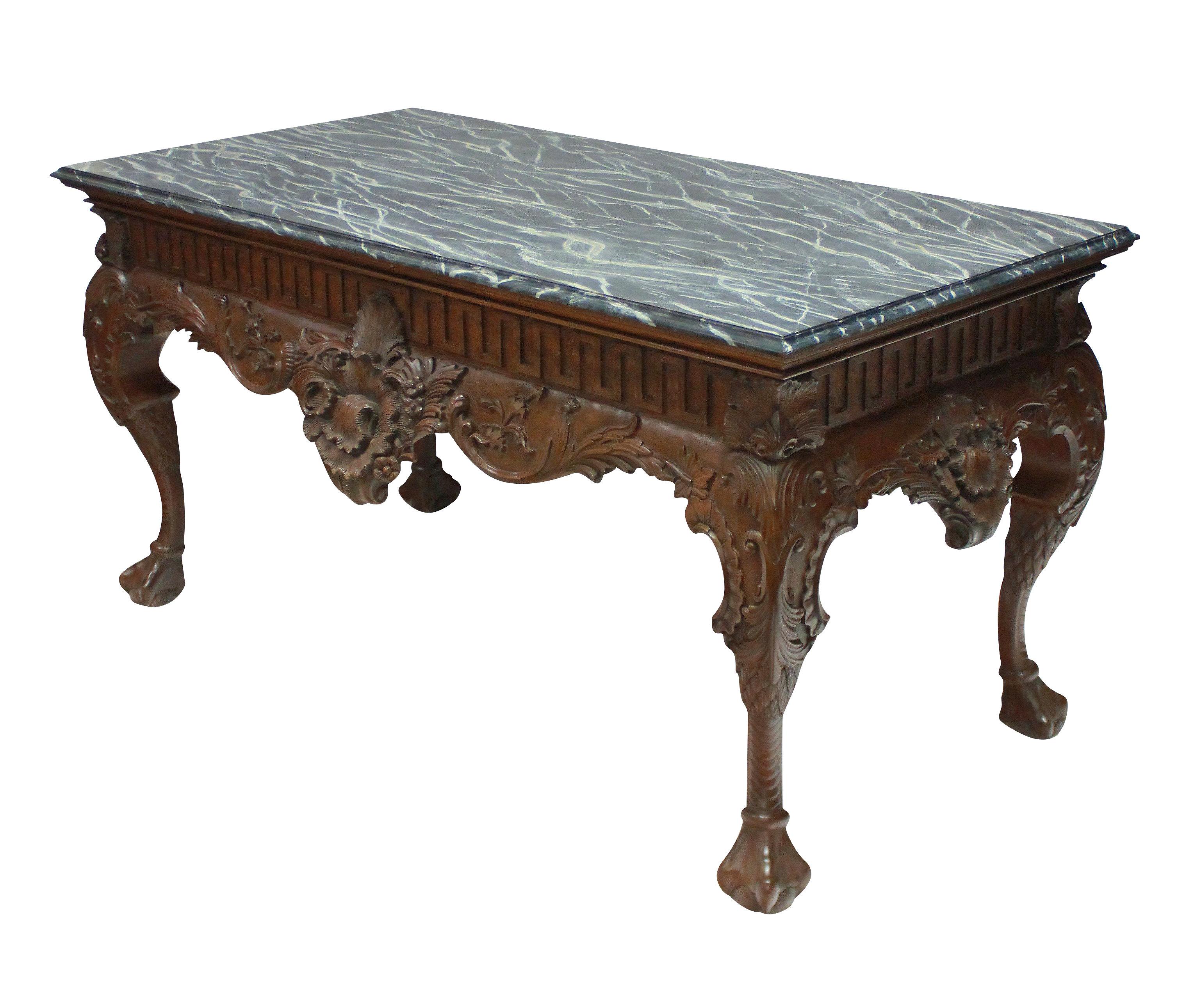 A large and beautifully carved George II Style mahogany centre table, with Greek key frieze and a grey variegated faux marble top. It is carved on all four sides, so could be used as a centre table, or sofa table/console.